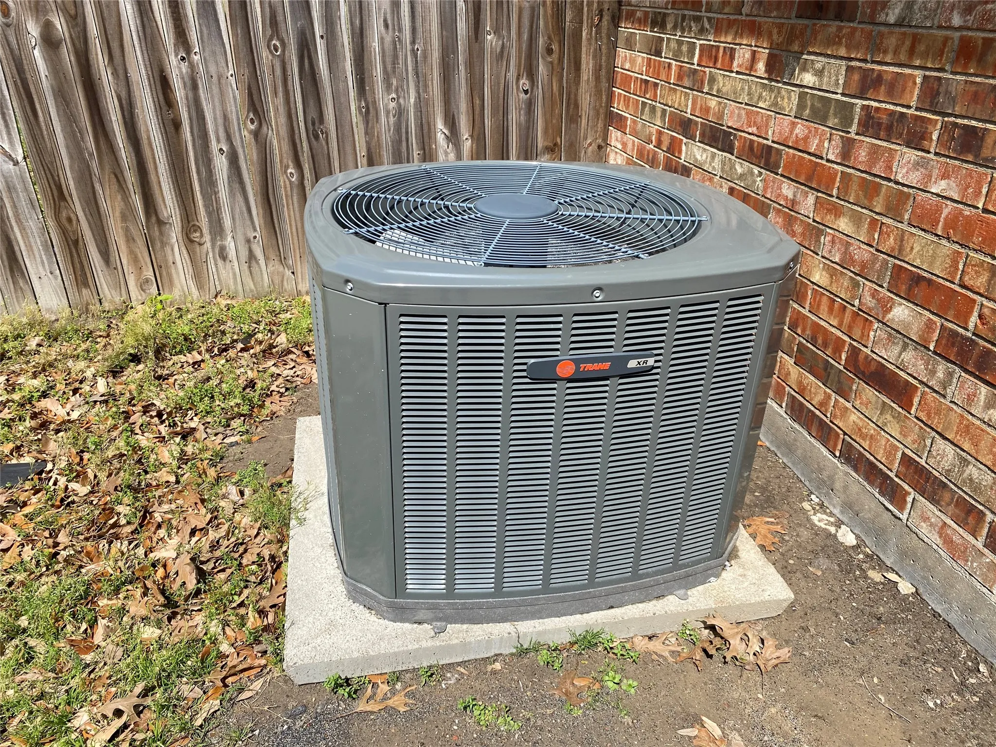 Details with central air condition unit and brick siding