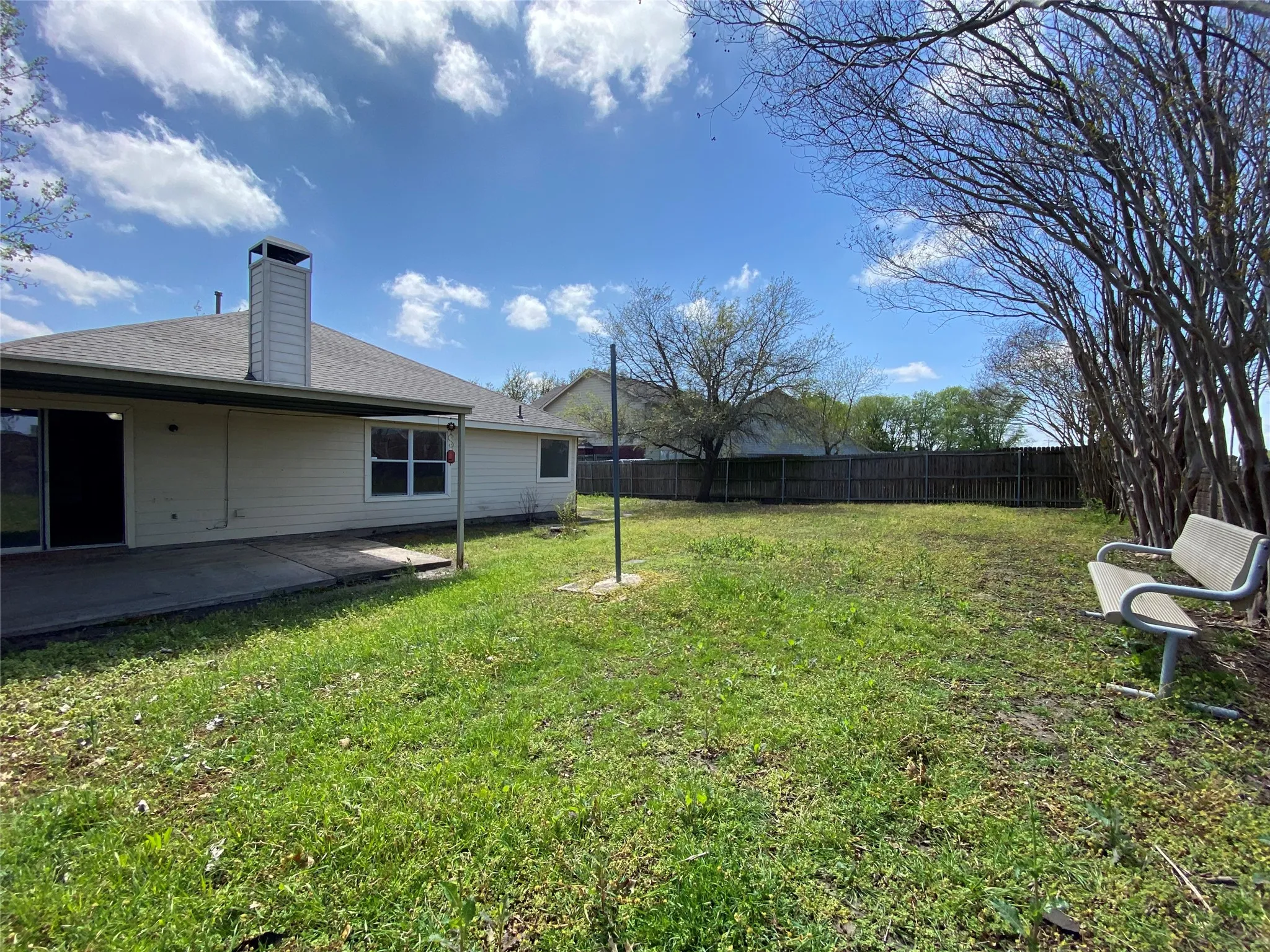View of yard with fence and a patio area