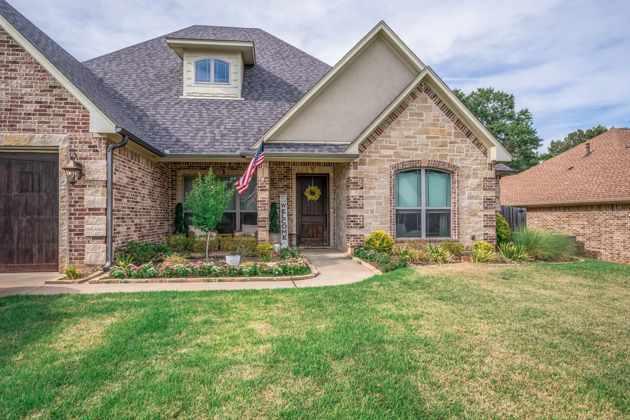 Mixed stone and brick exterior with a dormer window