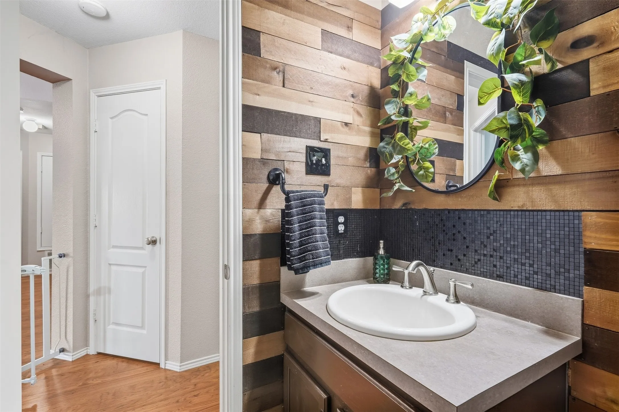 Recessed lighting, wood-finish flooring, and light wall tones