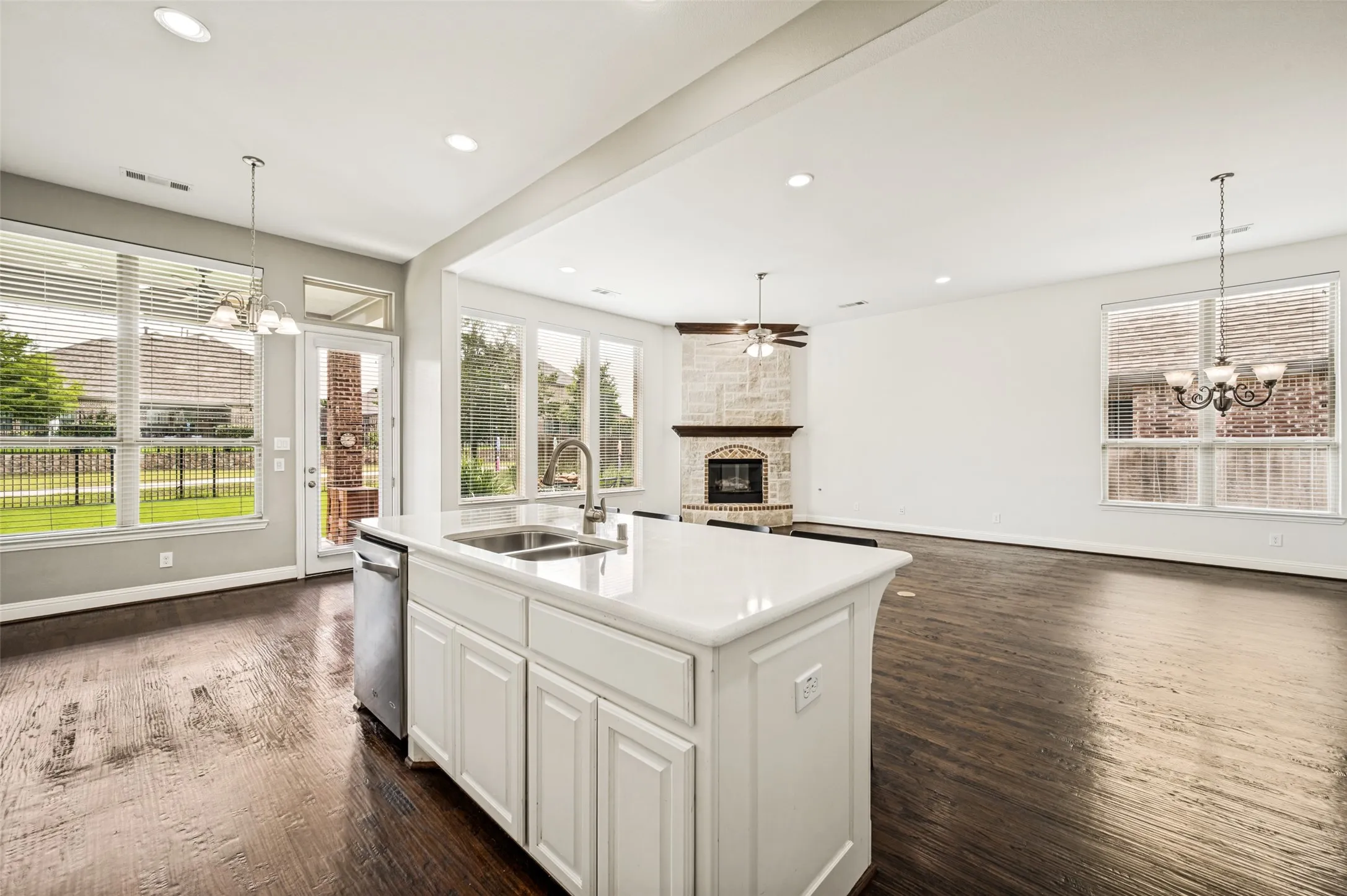 View from Kitchen overlooking wall of windows, living area & breakfast room