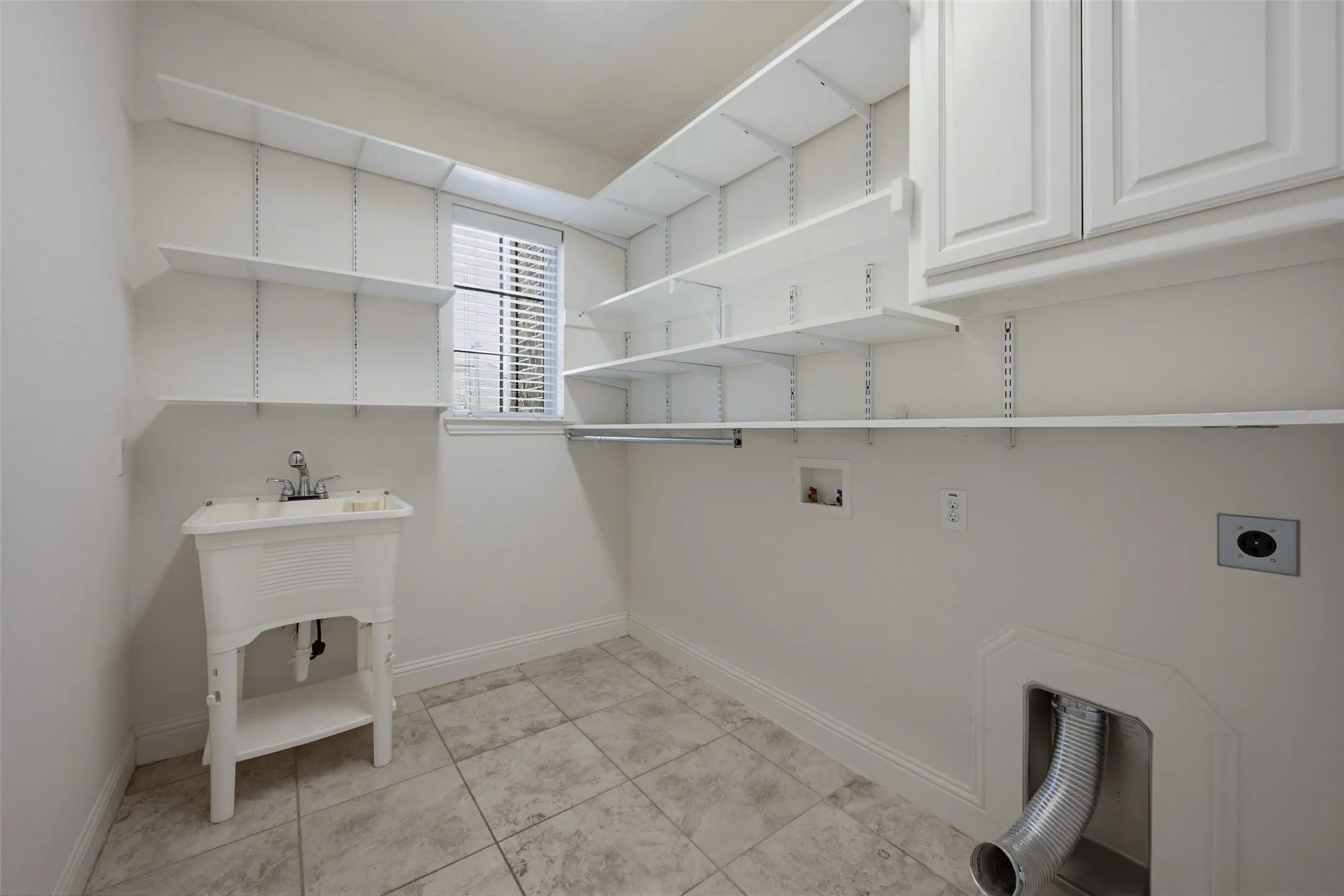 Large utility with shelving, cabinets and sink