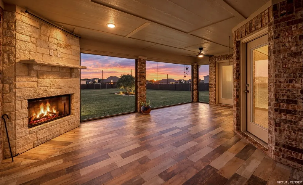 Expansive covered patio featuring a stone-clad fireplace, wood-finish flooring, brick exterior walls, and recessed lighting, Remote Solar Screens