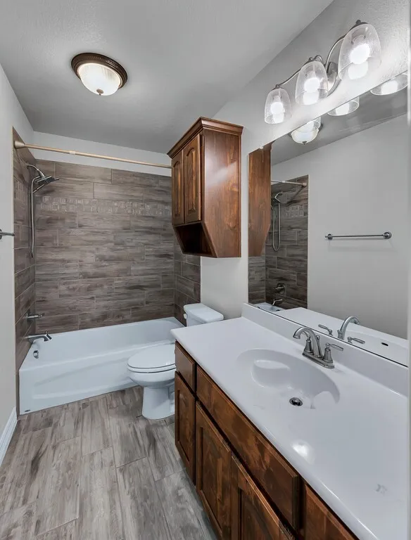 Wood-finish flooring with a white vanity featuring a single basin sink