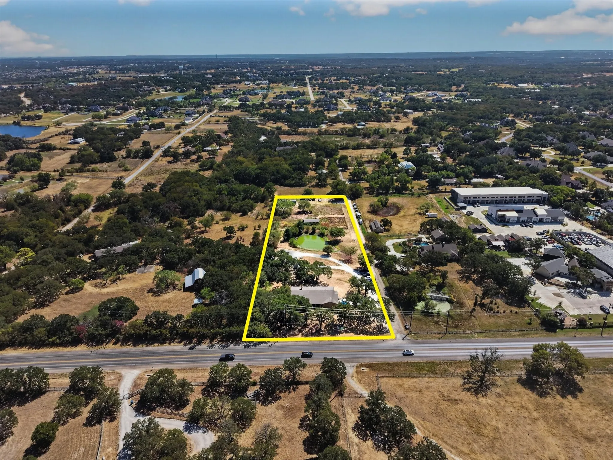 Full property footprint with approximately 3.25 acres, established pond, existing improvements, and surrounding Argyle landscape.