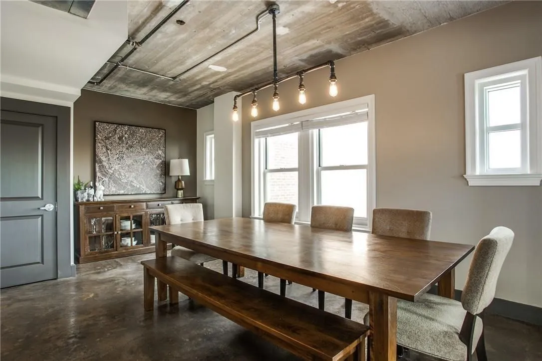 Exposed concrete ceiling with industrial-style lighting fixture