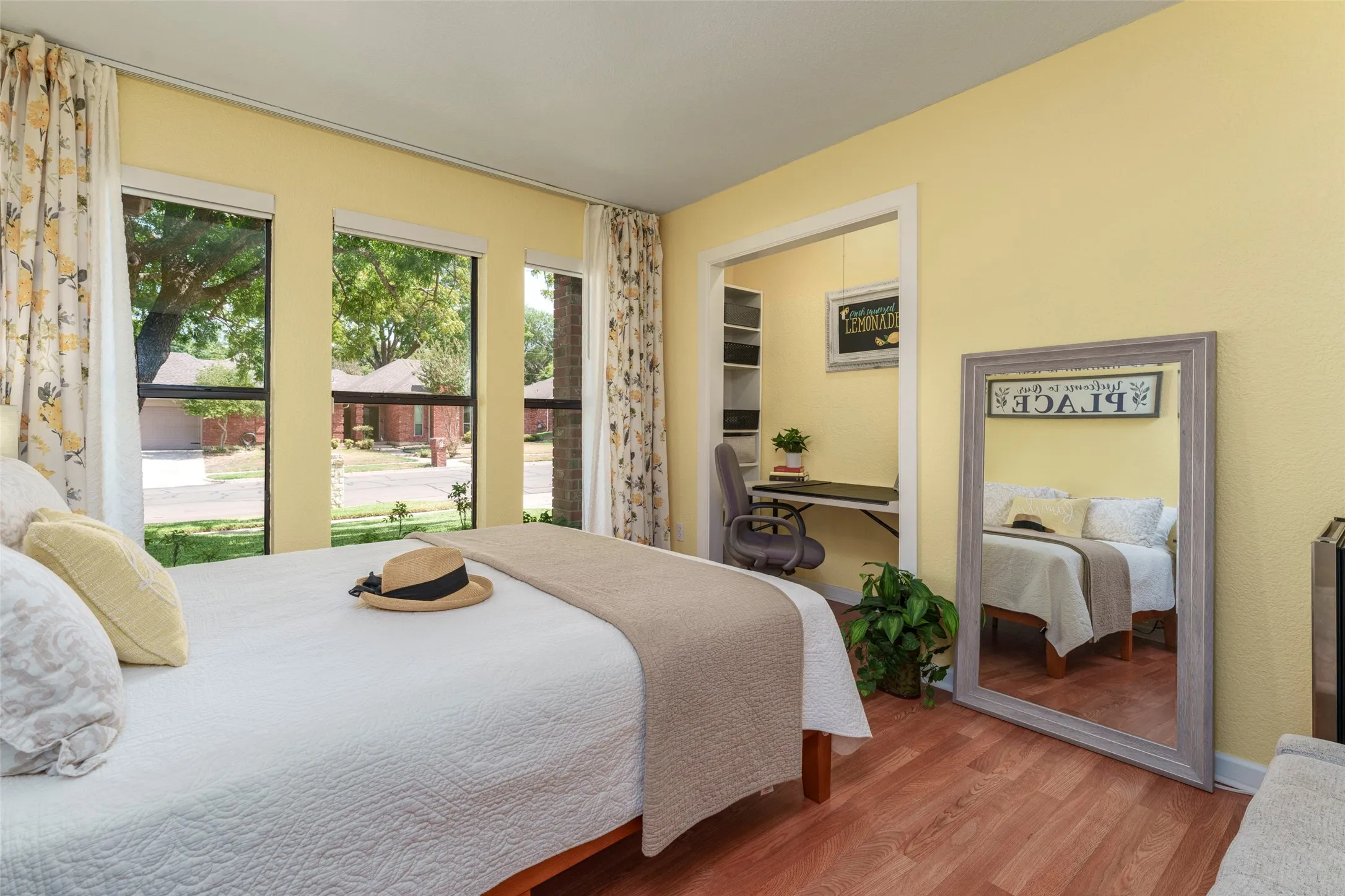 Motorized blinds. Wood-finish flooring, multiple windows, and a dedicated alcove.