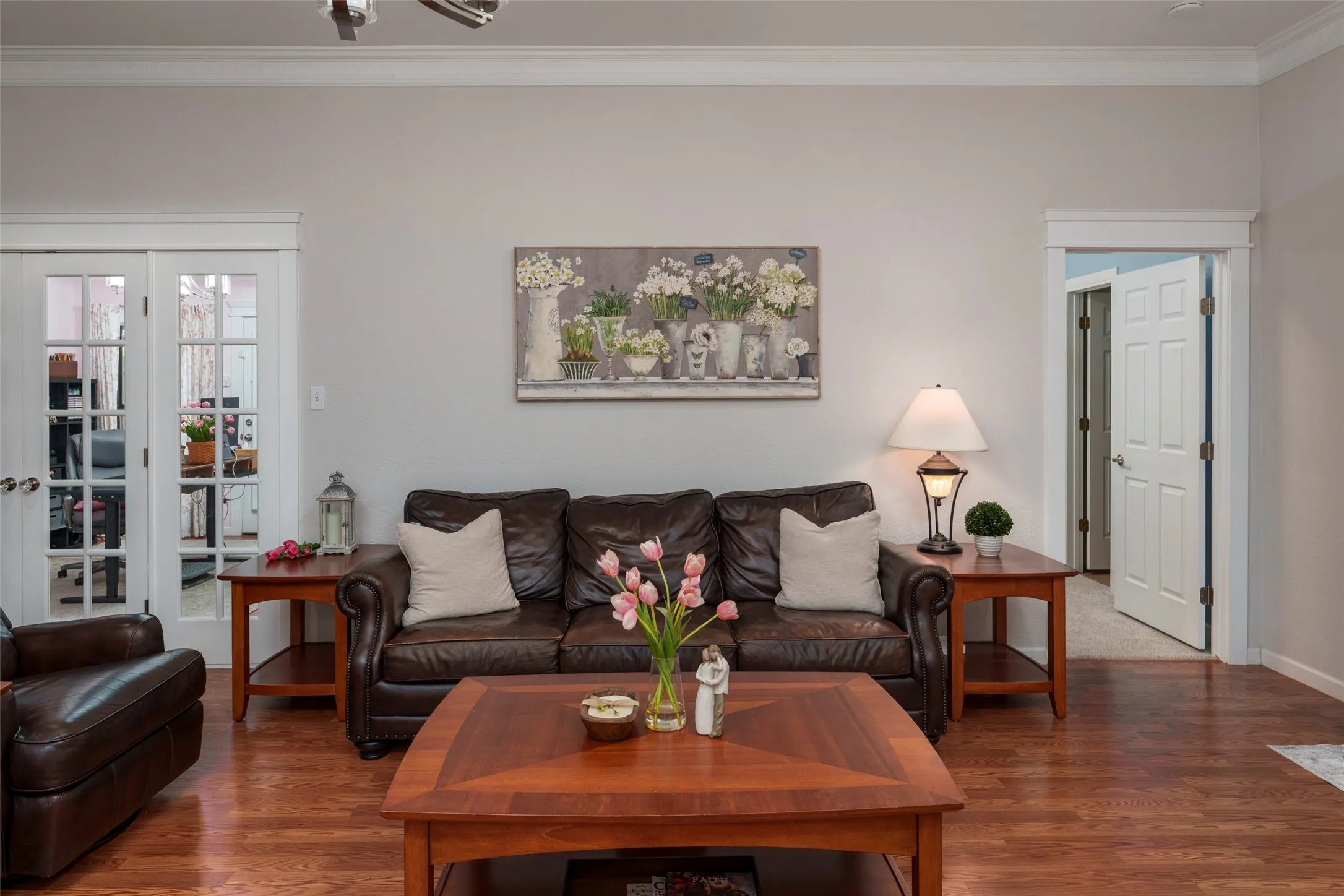 Full Glass Storm Doors & Warm wood-finish flooring, white crown molding, and white trim accents