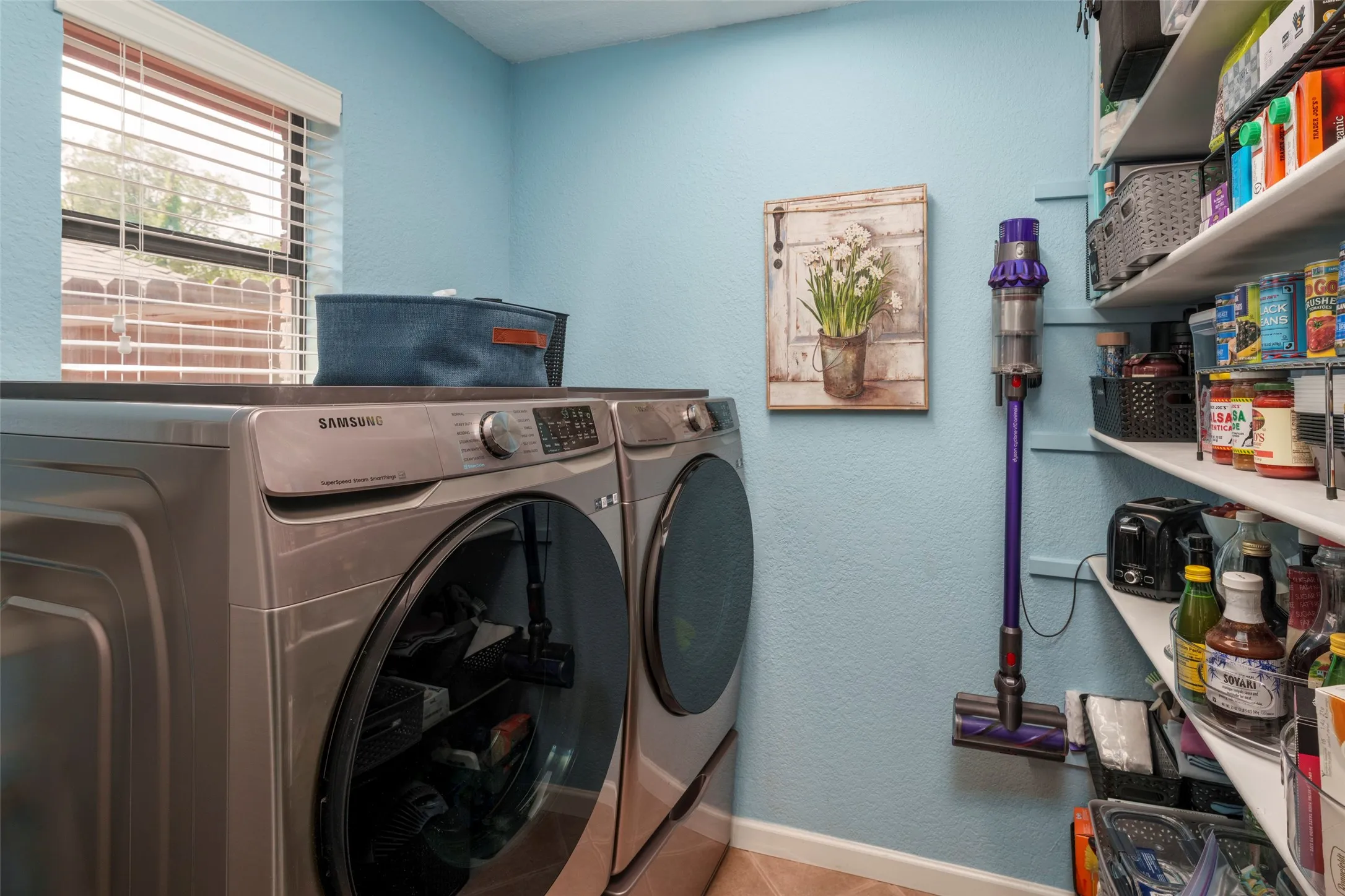 Laundry area  with built-in shelving.