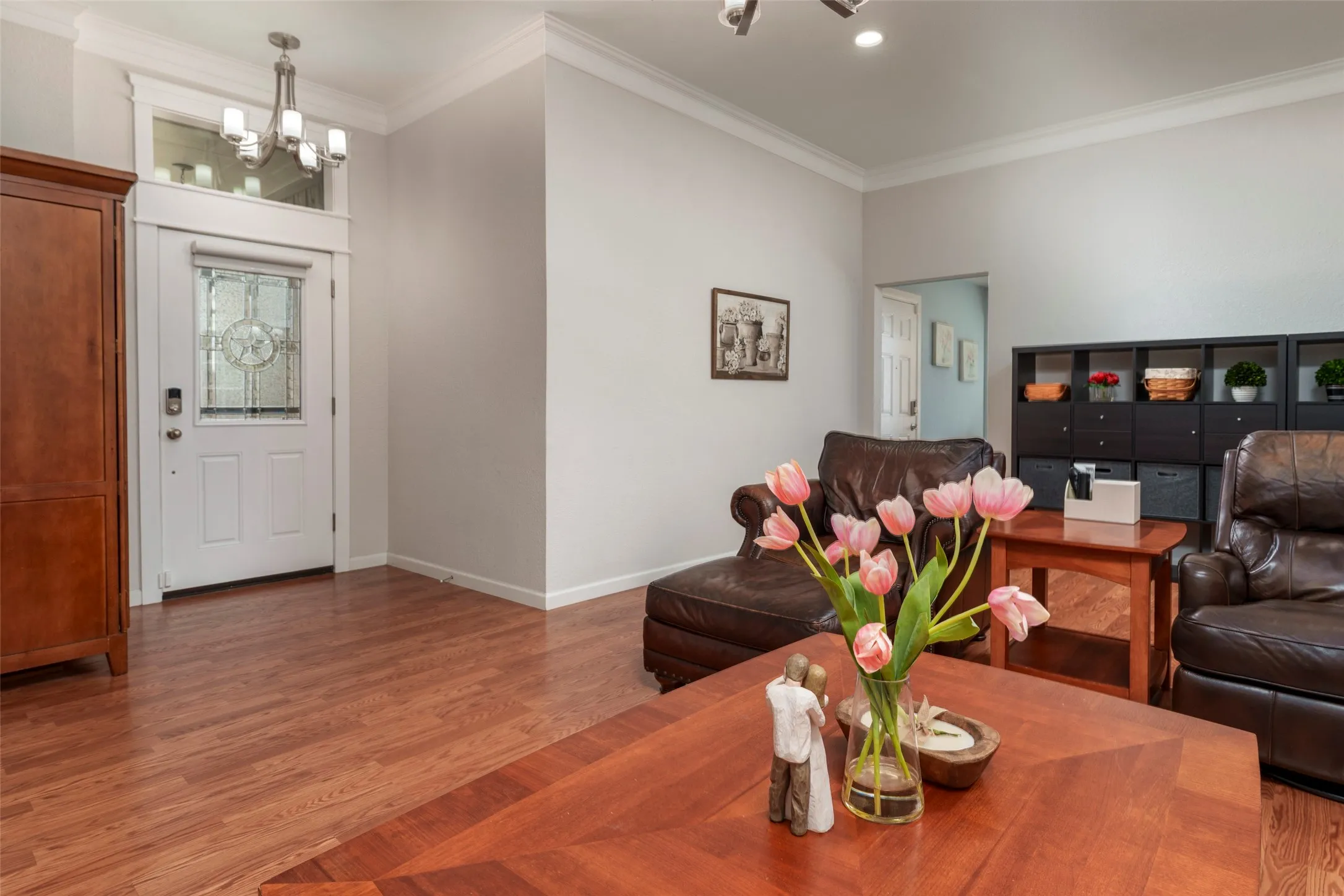 Full Glass Storm Doors & wood-finish flooring throughout, crown molding, and a white entry door with decorative glass inlay