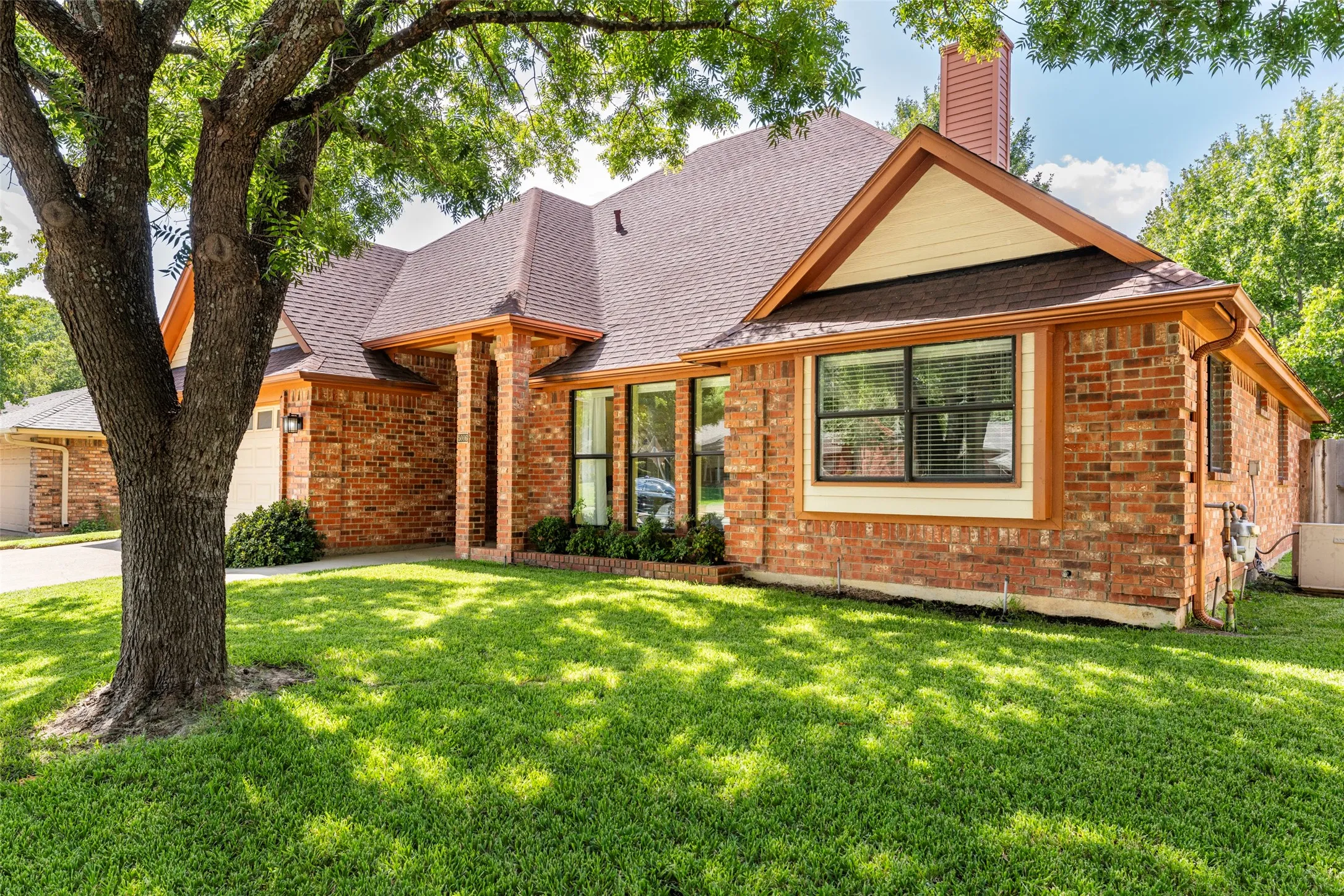 Red brick exterior with a brown shingle roof