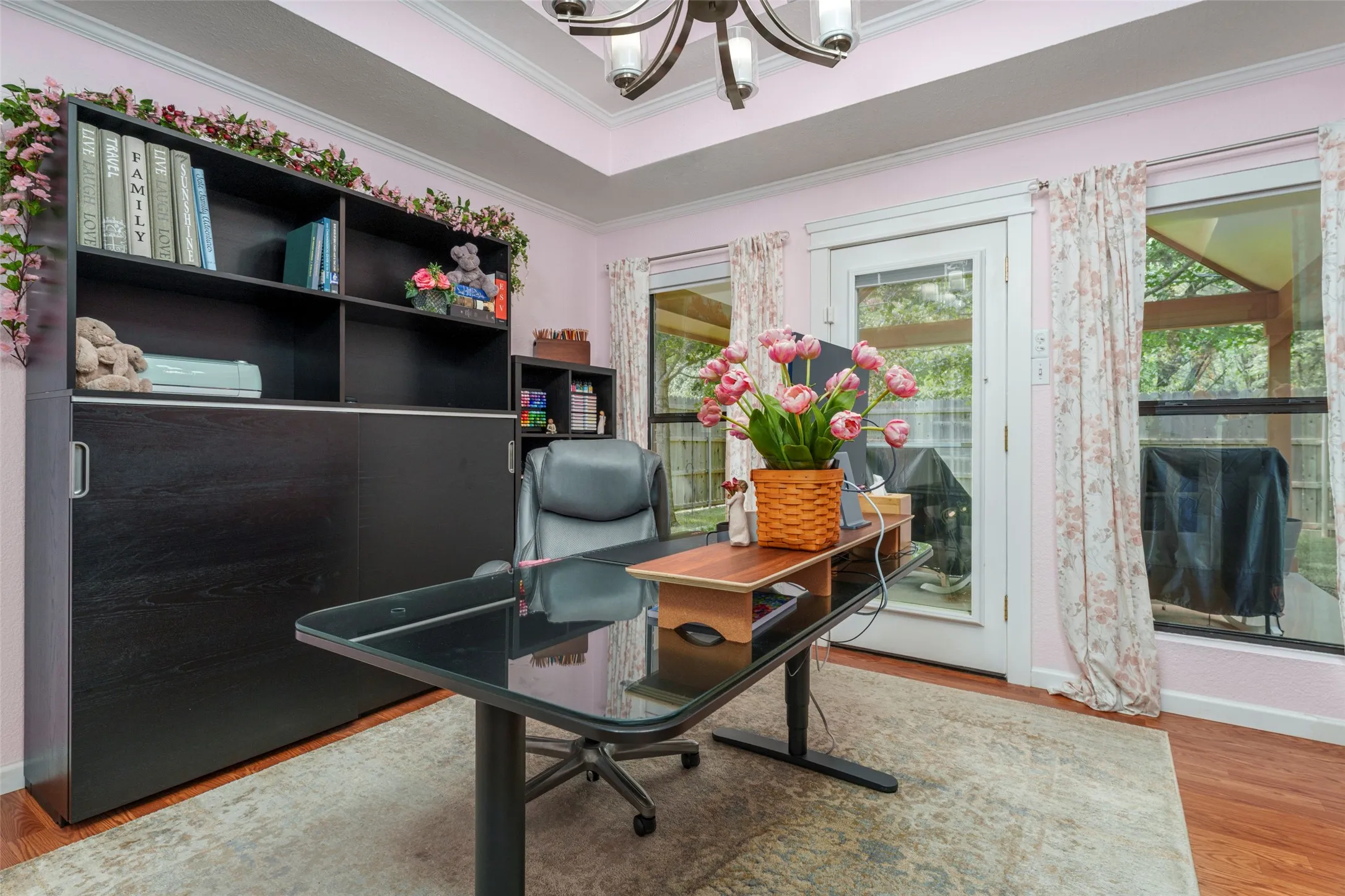 Wood styled flooring, Glass Door with pull down blinds inside, full glass storm door and large windows.Features motorized blinds