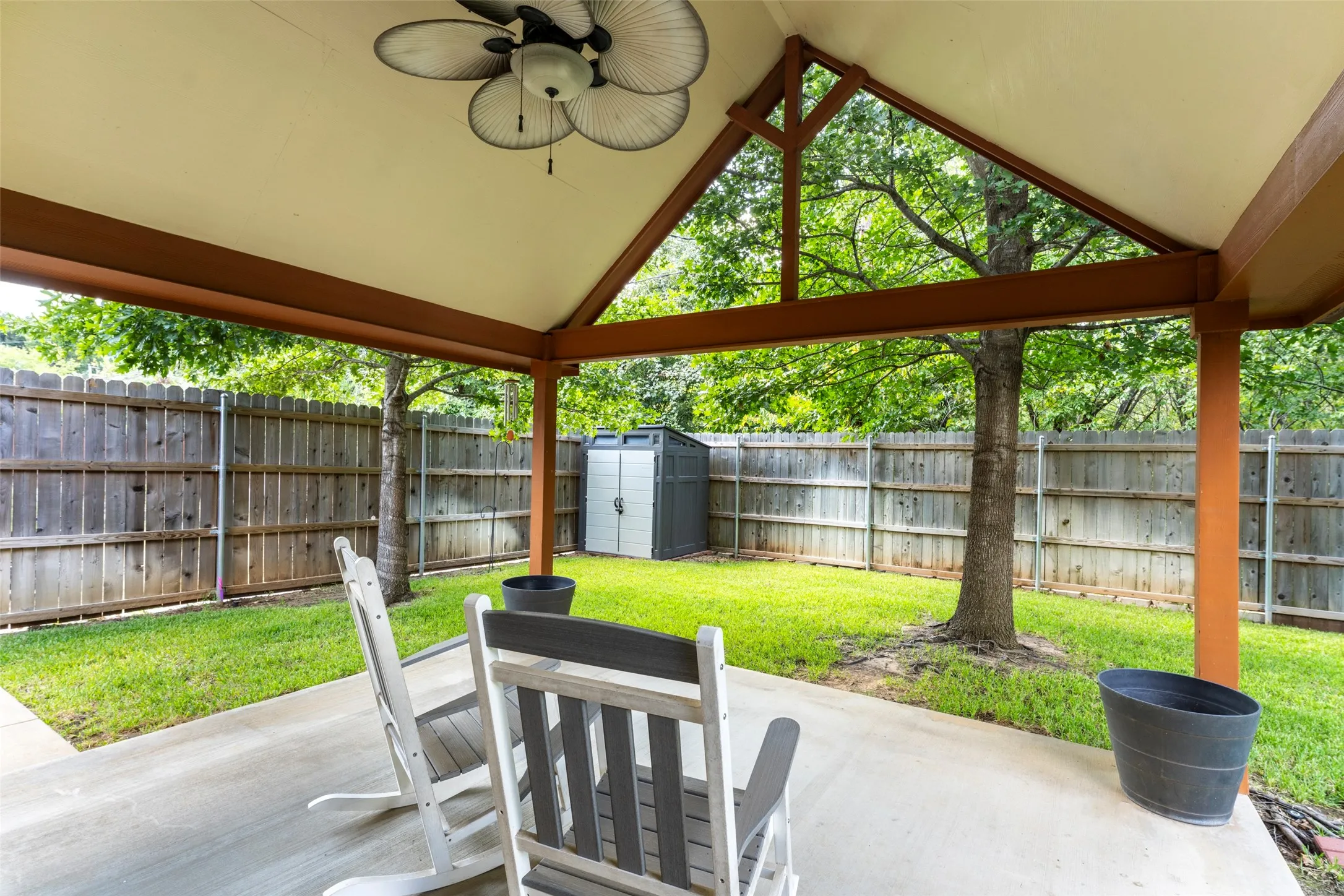 15x15 Covered patio with a concrete surface, exposed beams, and a ceiling fan
