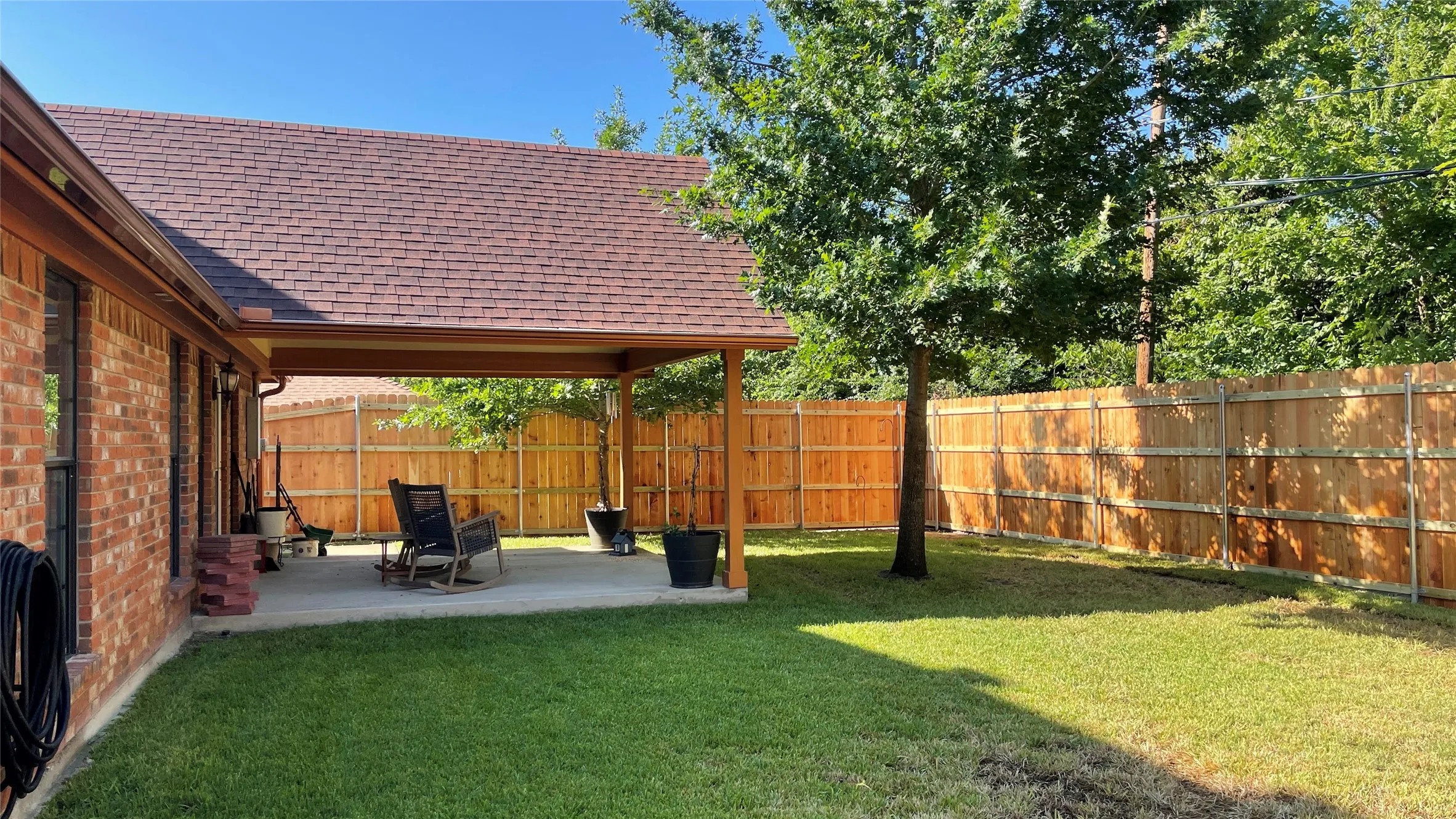 Expansive green lawn with a wood privacy fence. Sprinkler system for the front and back yards.
