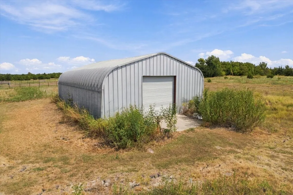 30X50+- Metal shop with roll up door and concrete slab (with back exterior entry door)
