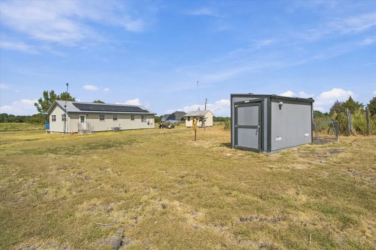 Gray chicken coop with attached chicken run