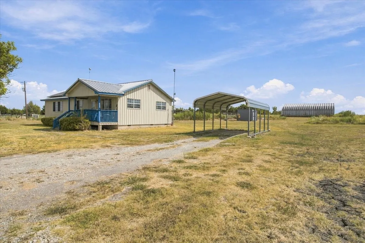 View of home, carport and metal shop