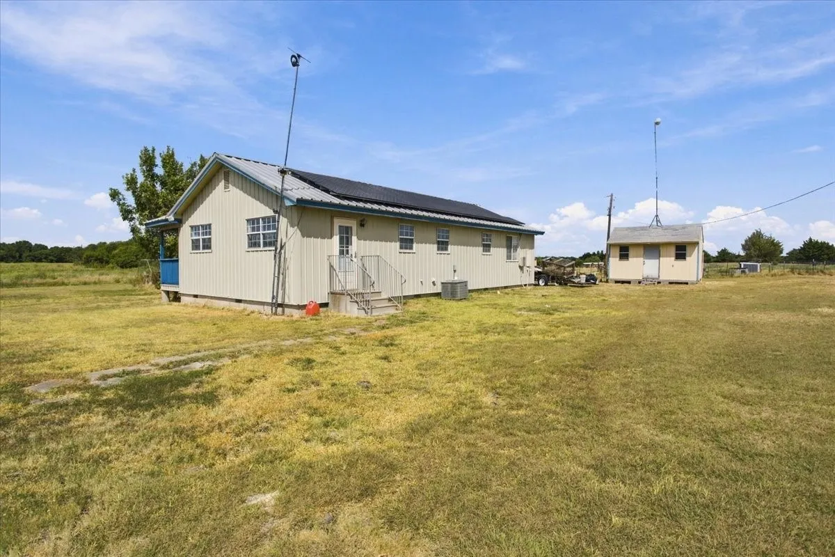 Back view of home and storage building
