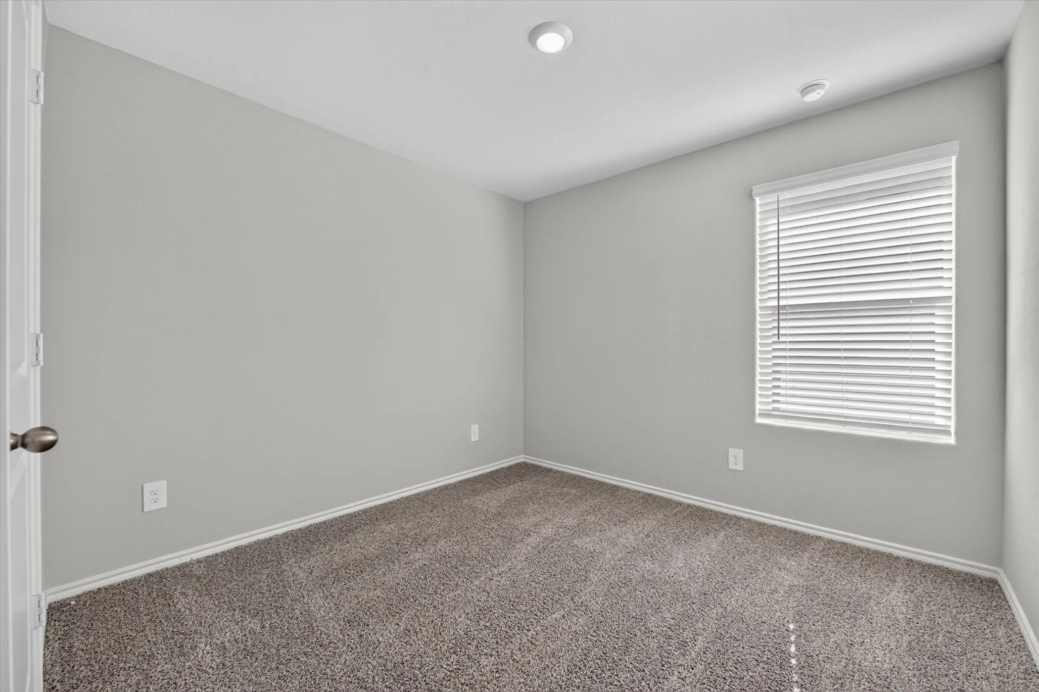 Recessed lighting, neutral wall paint, window with blinds, carpeted flooring, and baseboard trim