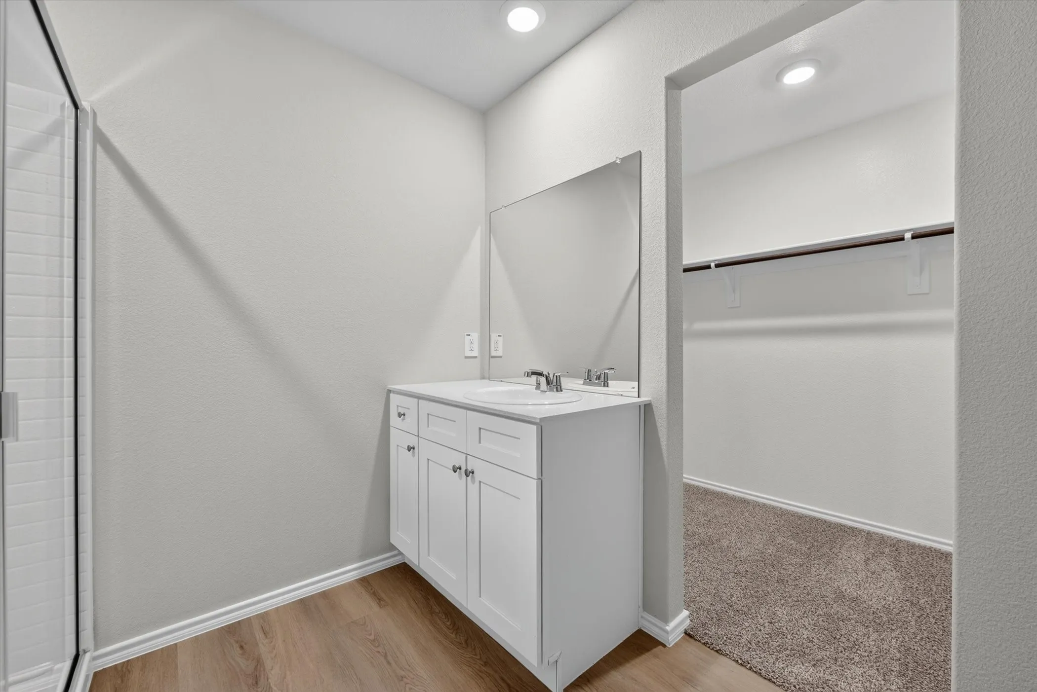White vanity with an integrated sink and chrome fixtures