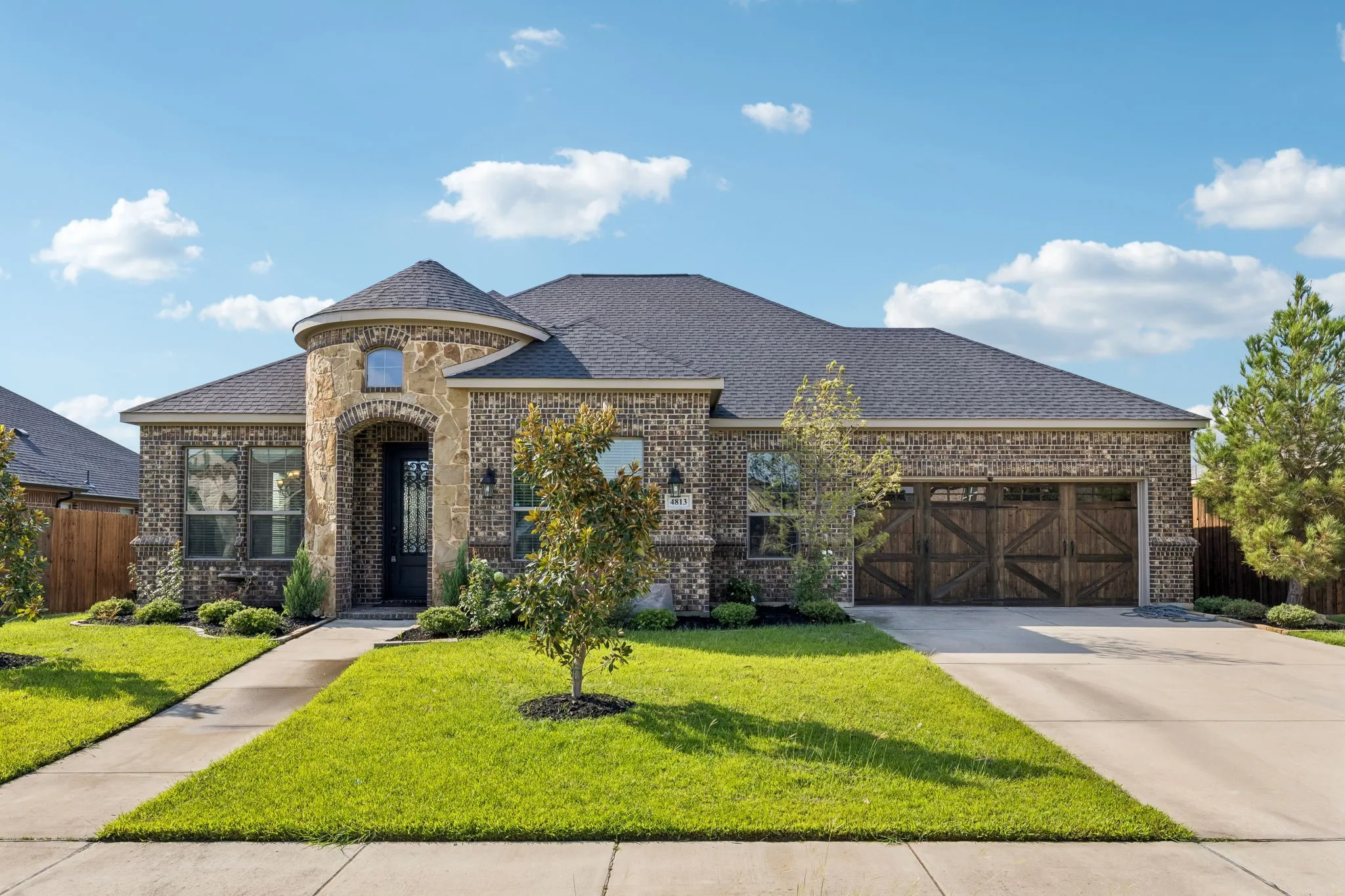 Brick and stone exterior featuring a turret-style architectural element