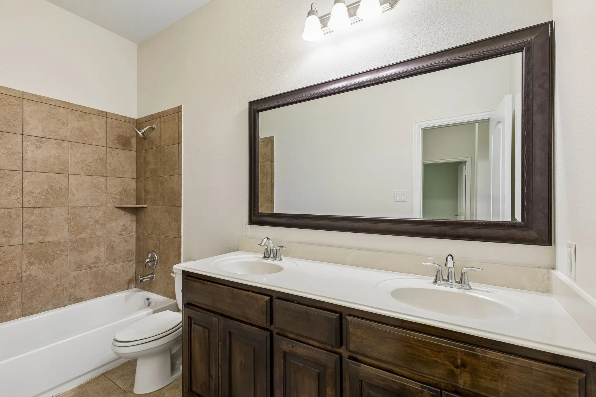 Double vanity with white countertop and integrated sinks