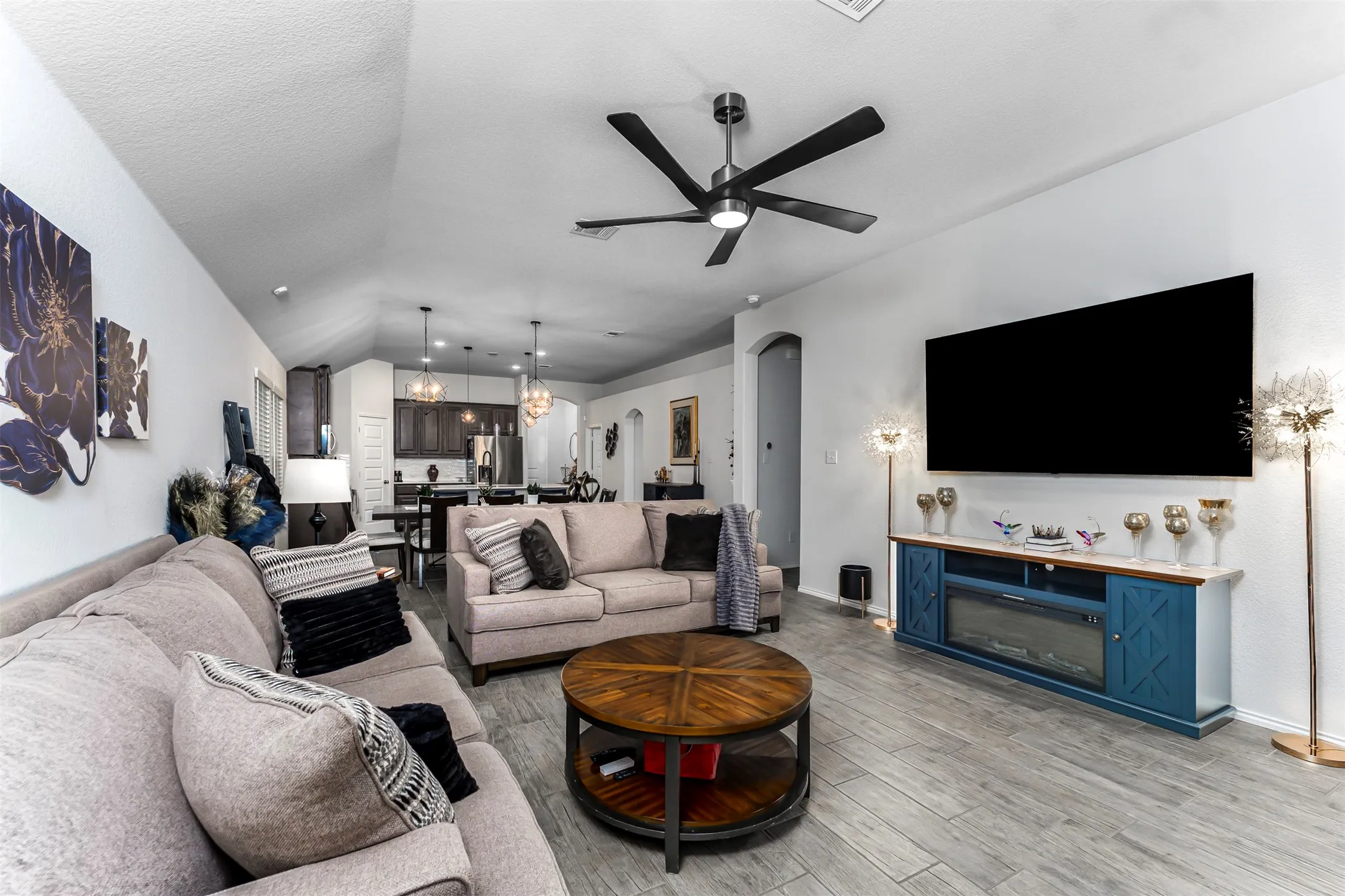 Vaulted ceiling, ceiling fan, wood-finish flooring, built-in media console, recessed lighting