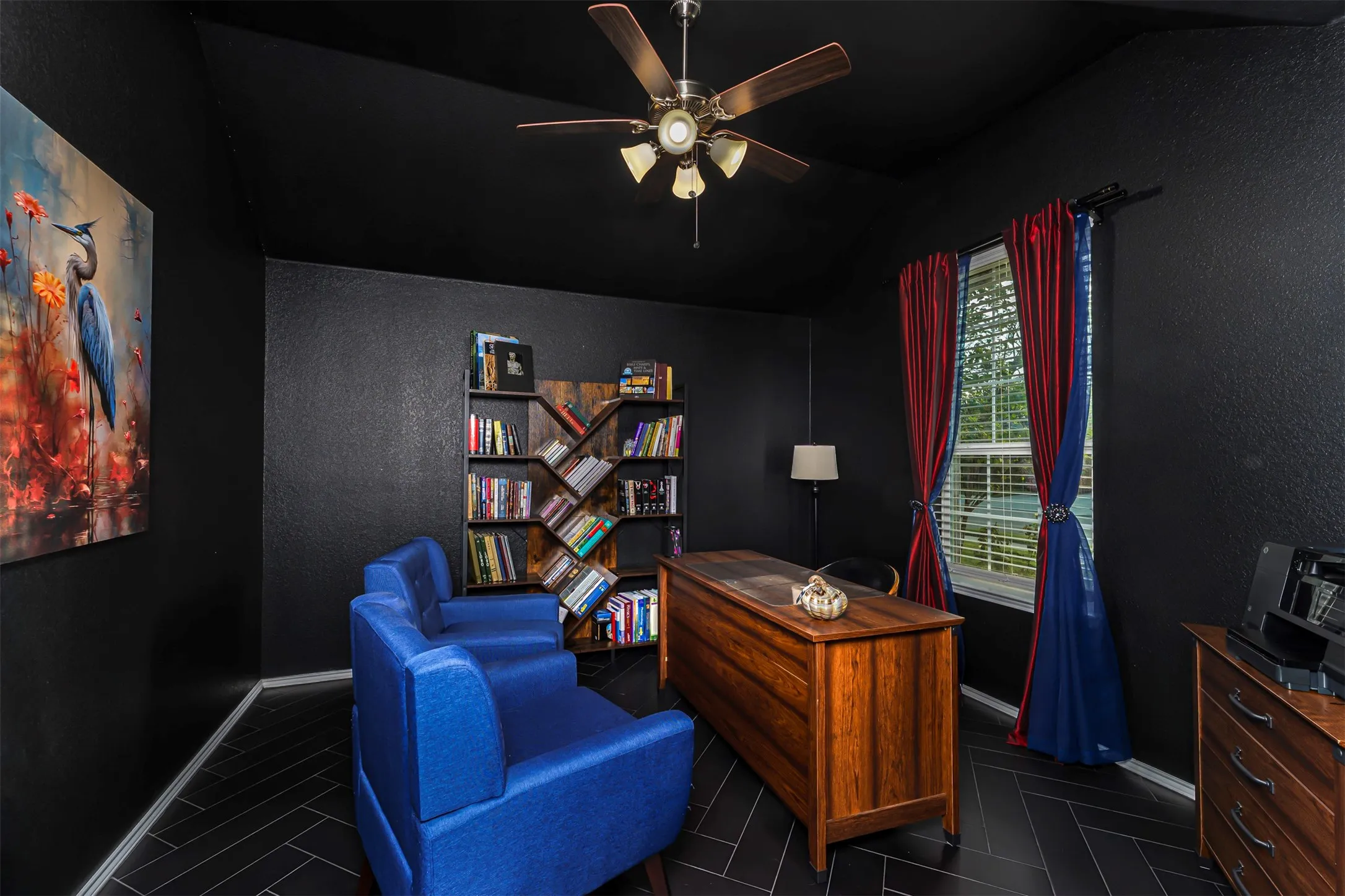 Vaulted ceiling with an attached ceiling fan, recessed window with blinds, and dark wood-finish flooring in a herringbone pattern