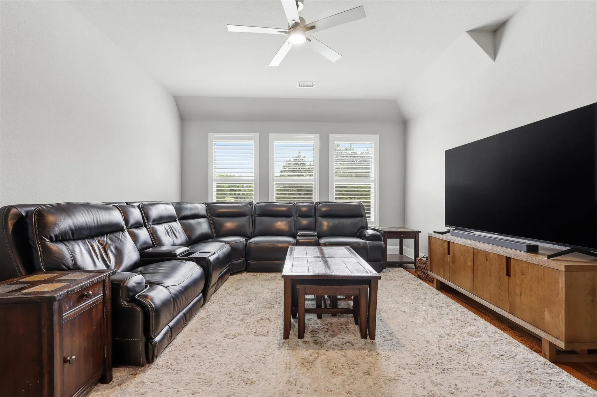Recessed lighting, ceiling fan, wood-finish flooring, multiple windows with blinds, and light-toned walls