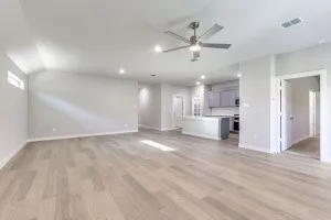 Expansive room featuring wood-finish flooring, recessed lighting, and a modern ceiling fan