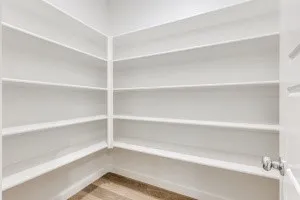 Built-in shelving, white finish, wood-finish flooring, interior door, door hardware