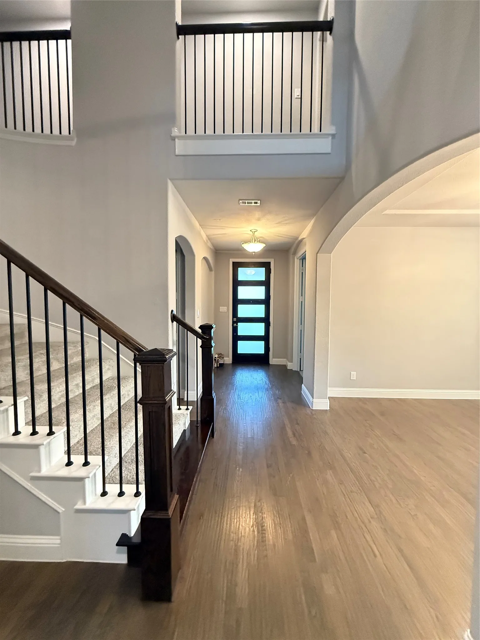 Hardwood flooring extending through the hallway and main living area