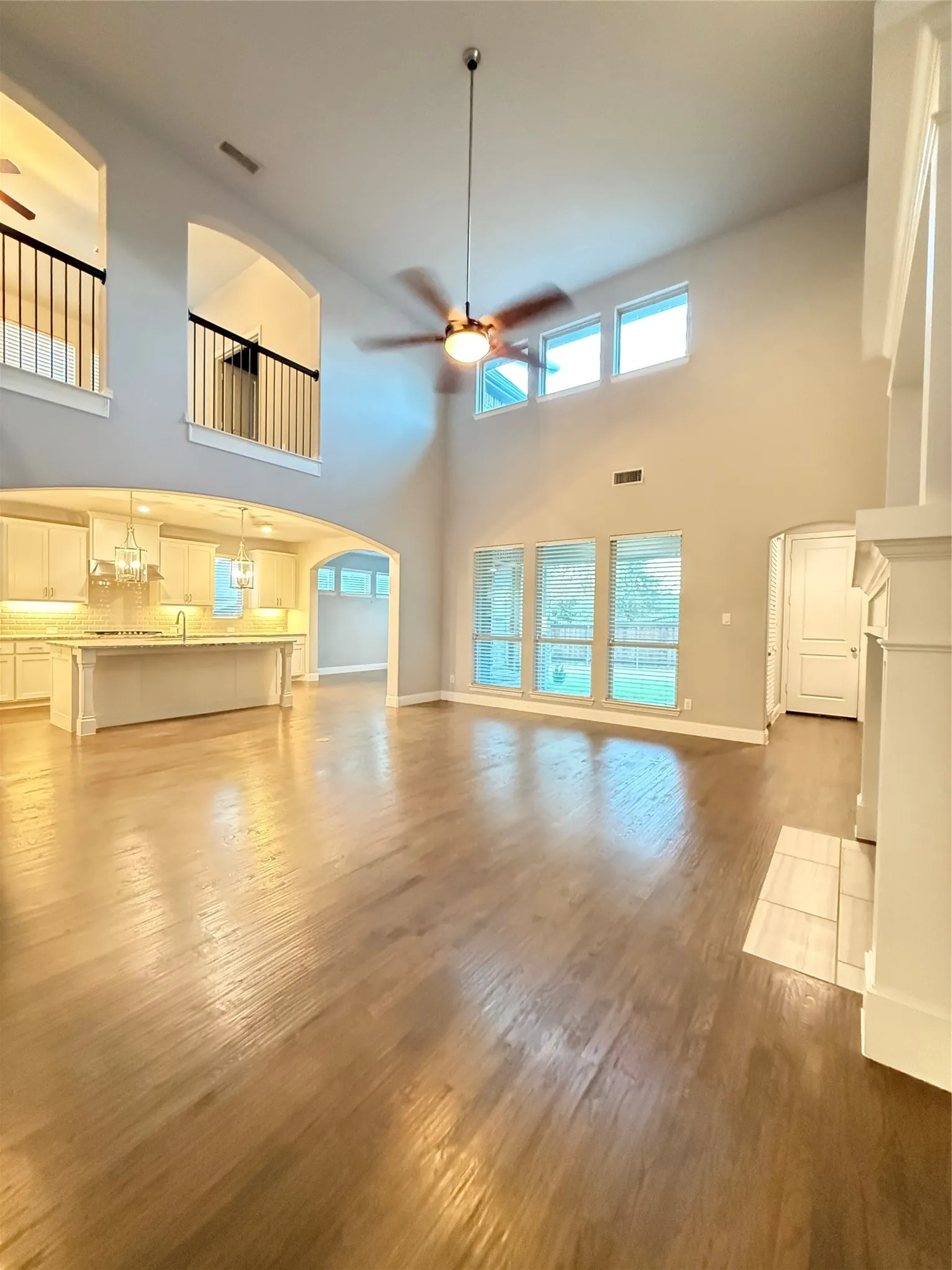 Vaulted ceilings, wood-finish flooring, and an open-concept layout