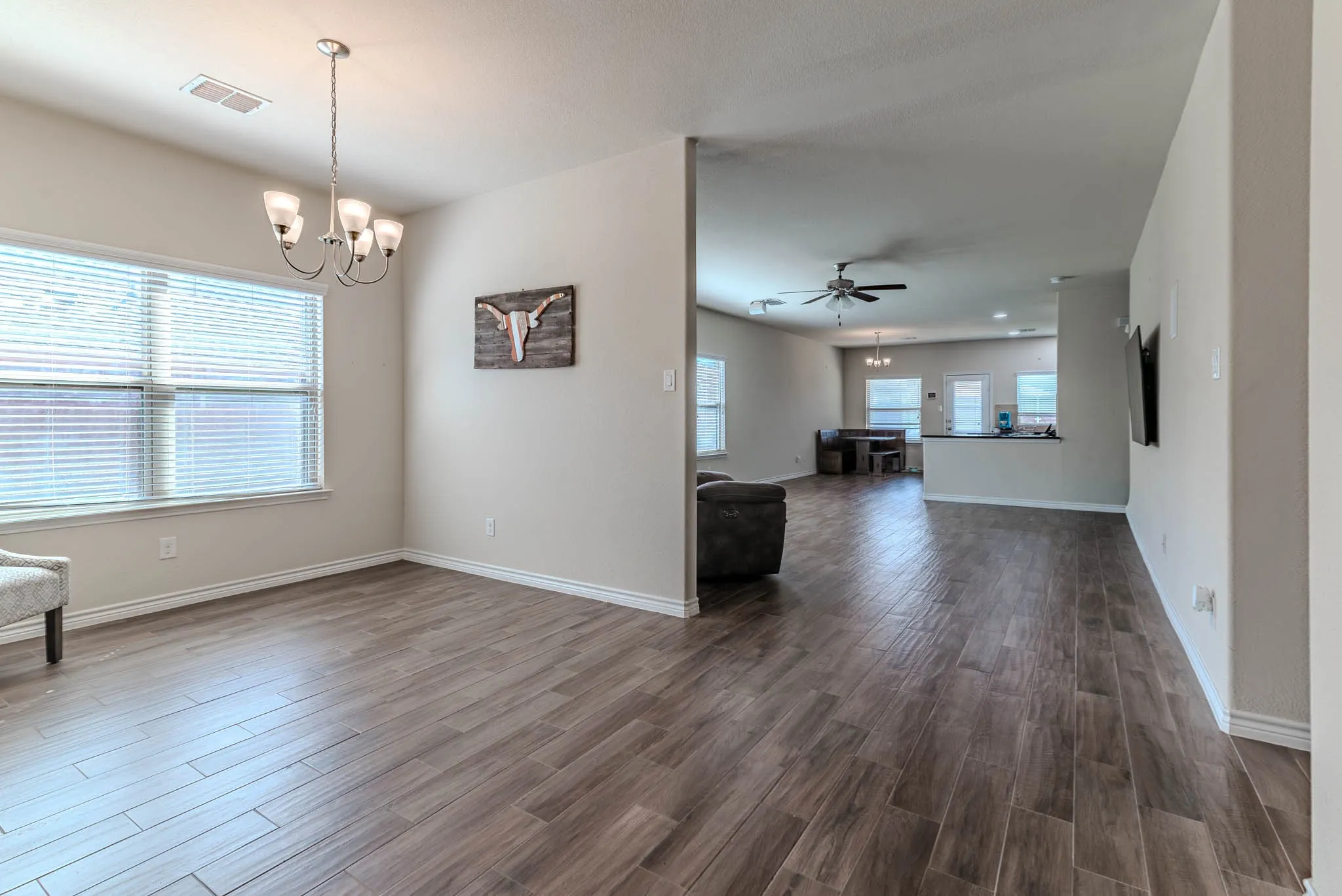 Entrance into home with wood-type flooring into a sitting or dining area