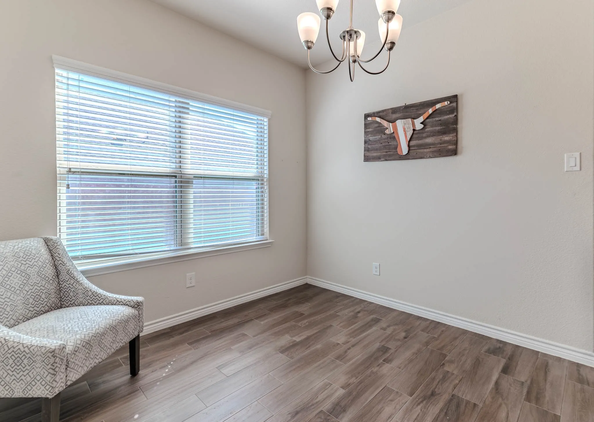 Entrance into home with wood-type flooring into a sitting or dining area