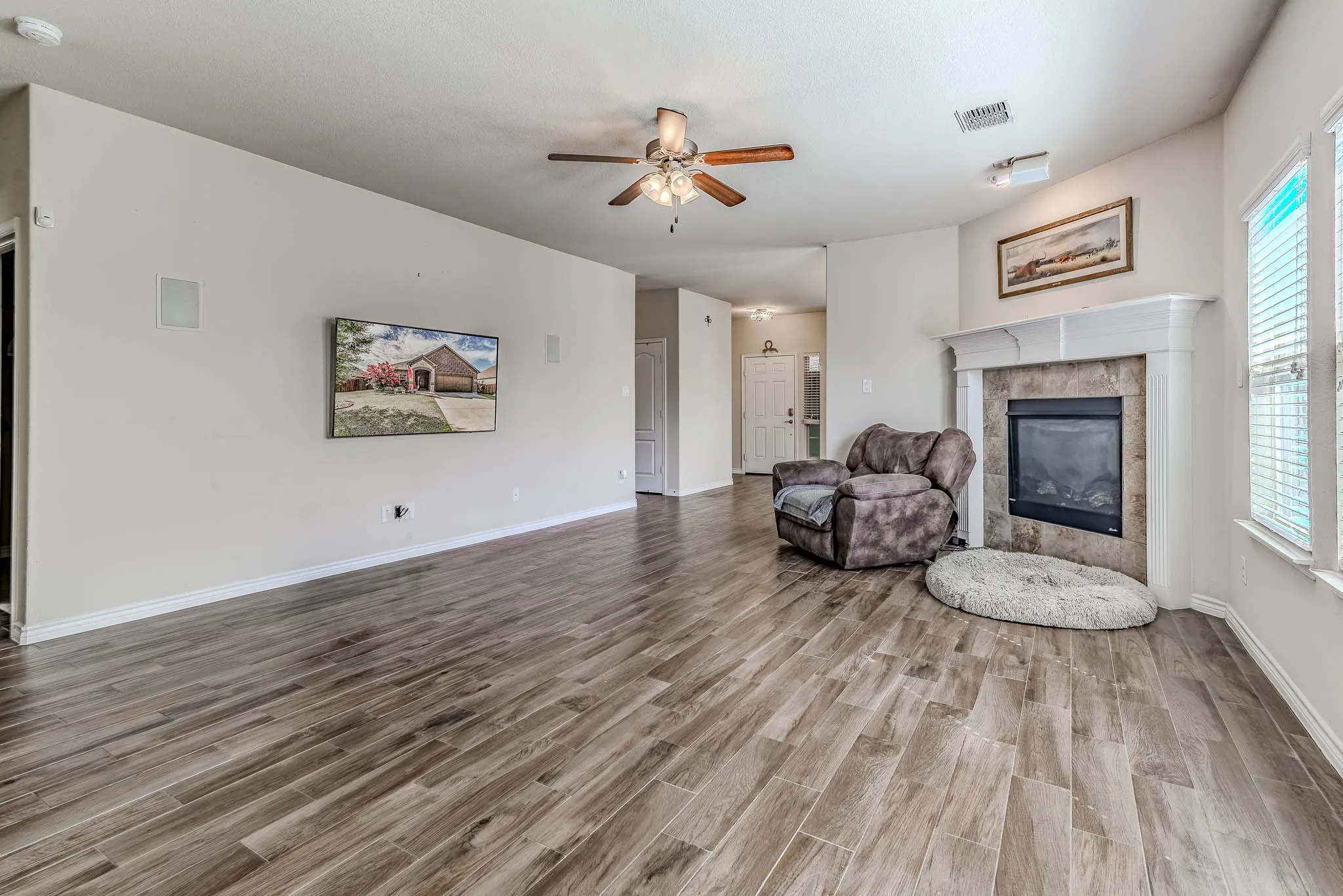 Spacious living area with wood-type flooring