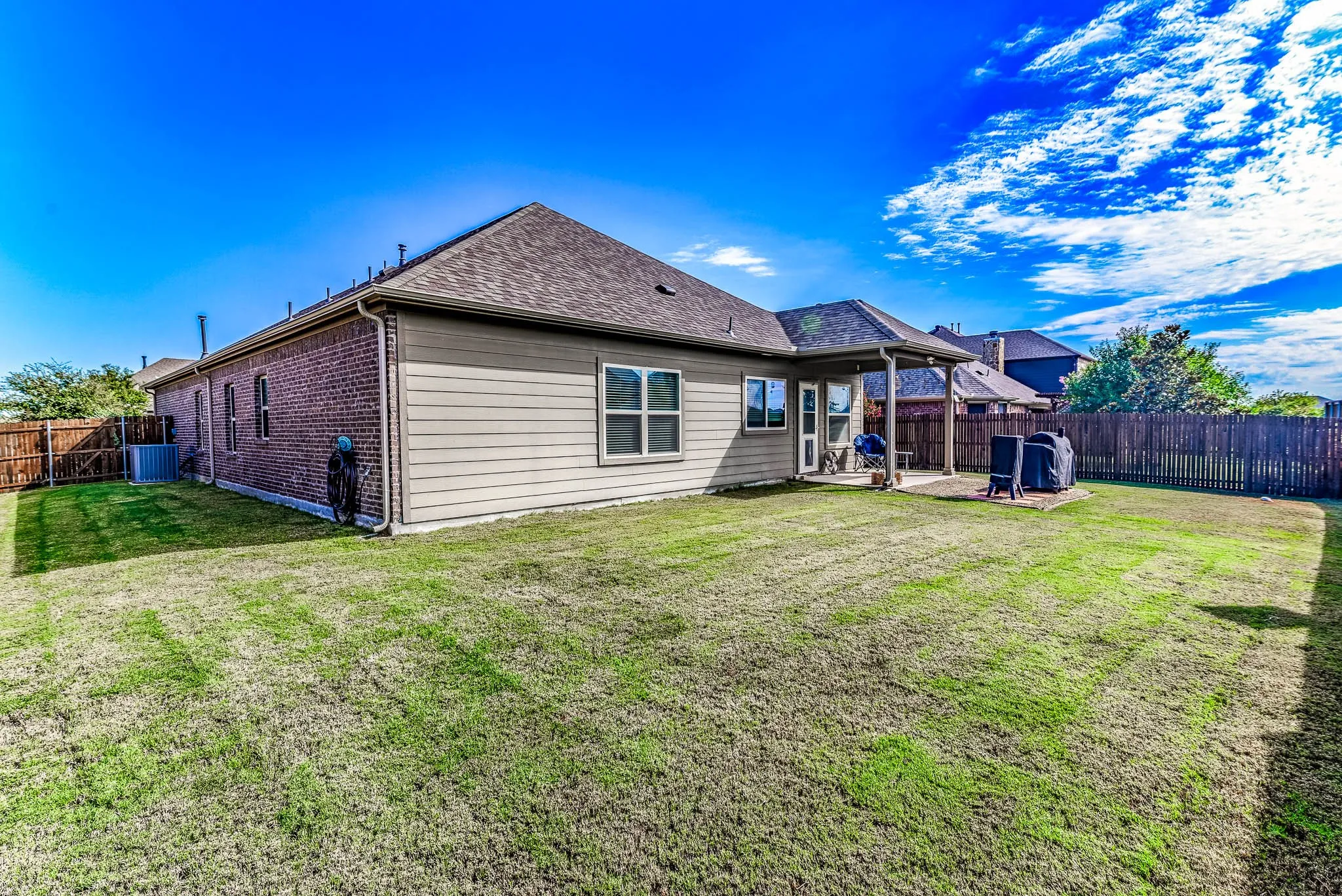 Rear view of house and a spacious yard
