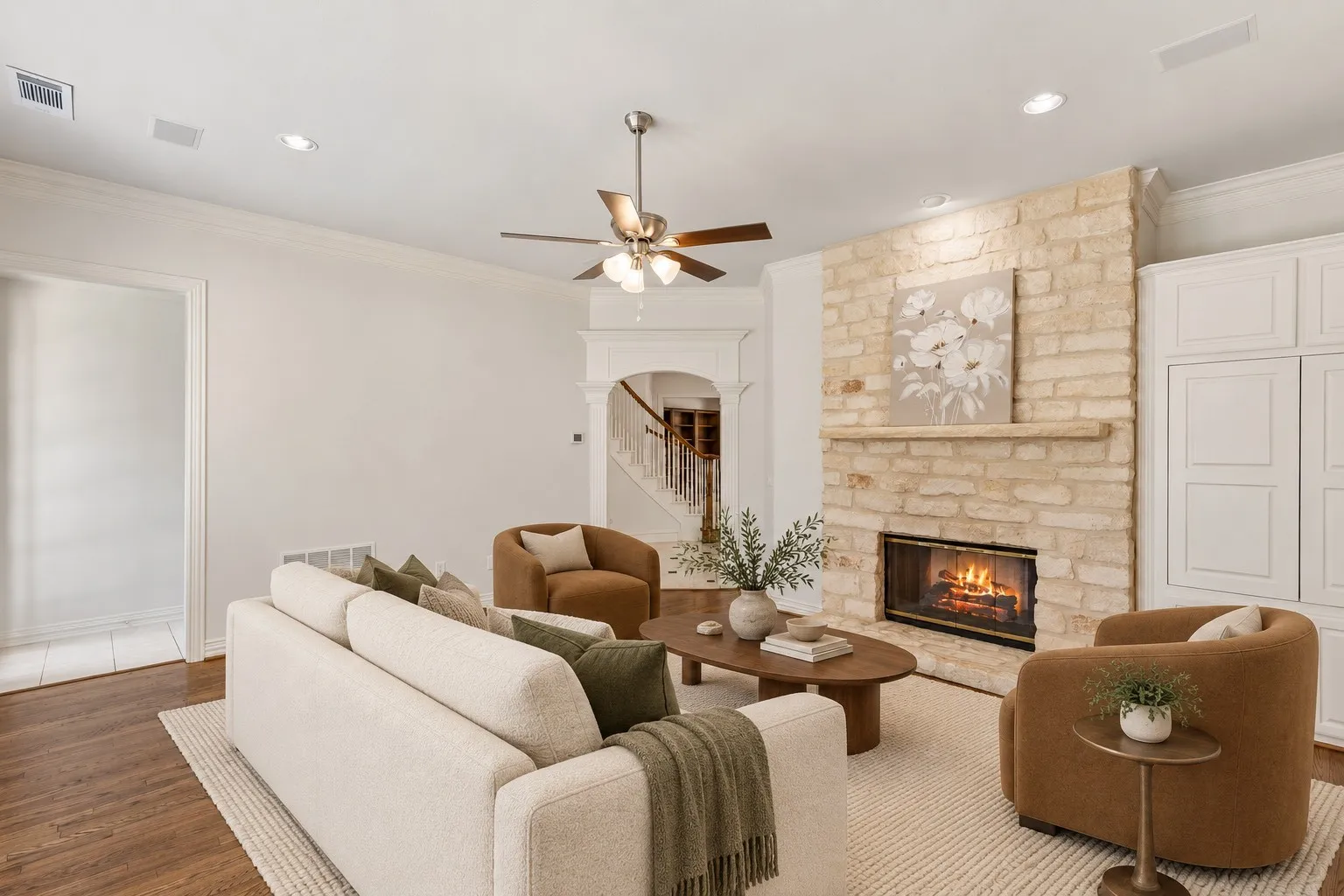 Austin stone fireplace and newly refinished hardwood floor in the den. (This photo is virtually staged.)