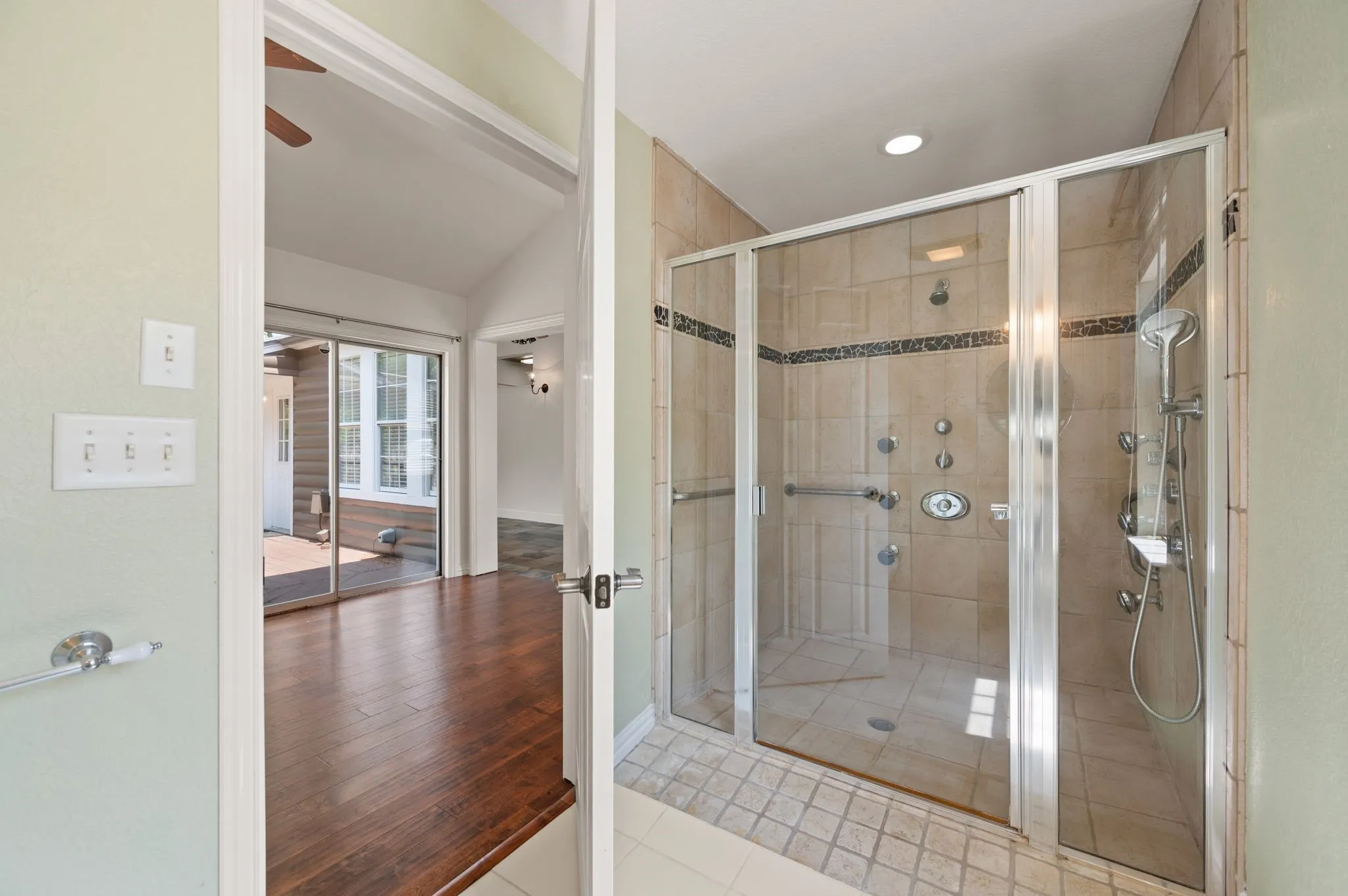Full bath with vaulted ceiling, baseboards, recessed lighting, tile patterned flooring, and a shower stall