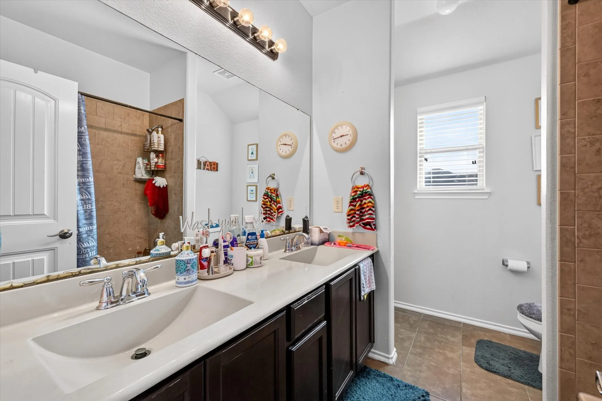 Double vanity with undermount sinks, chrome fixtures, and a white countertop