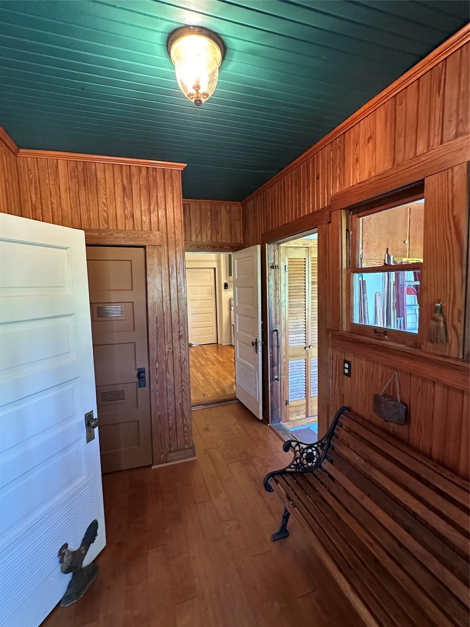 Wood-finish flooring, wood paneling, beadboard ceiling, and recessed lighting