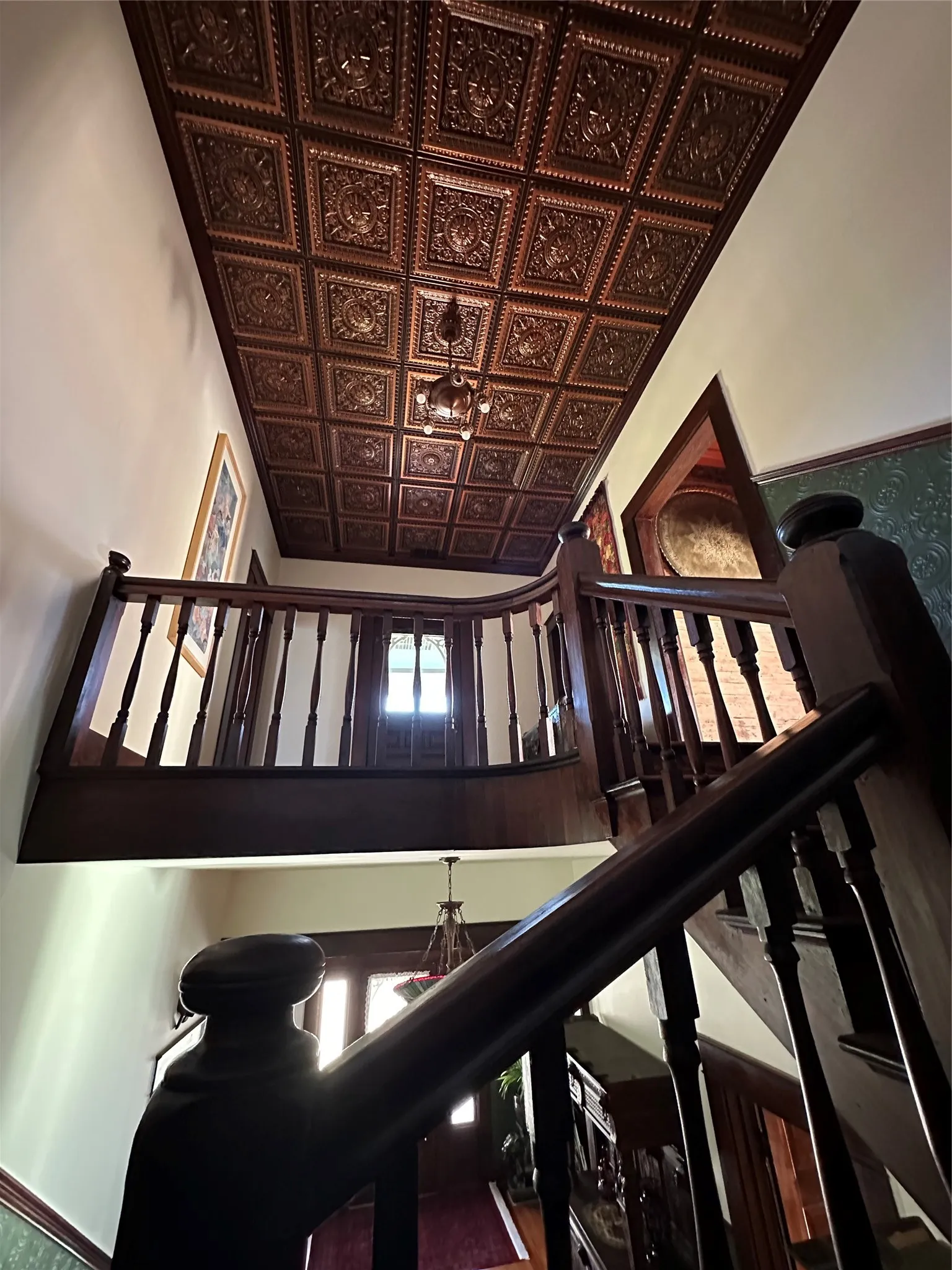 Ornate pressed tin ceiling with a decorative chandelier