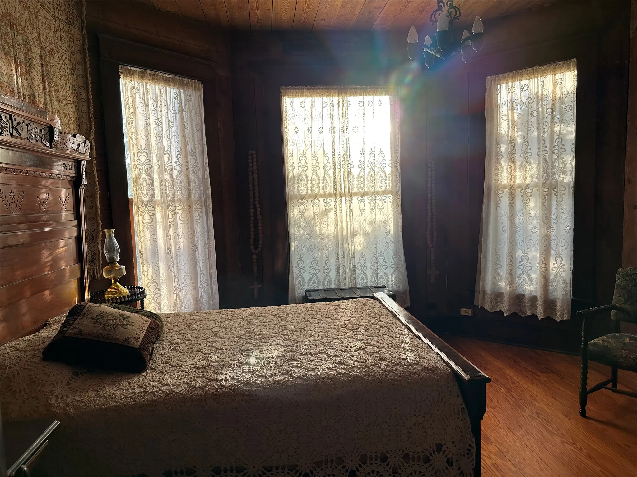 Hardwood flooring, wood-paneled walls, wood-paneled ceiling, chandelier, and multiple windows - Could be great B & B