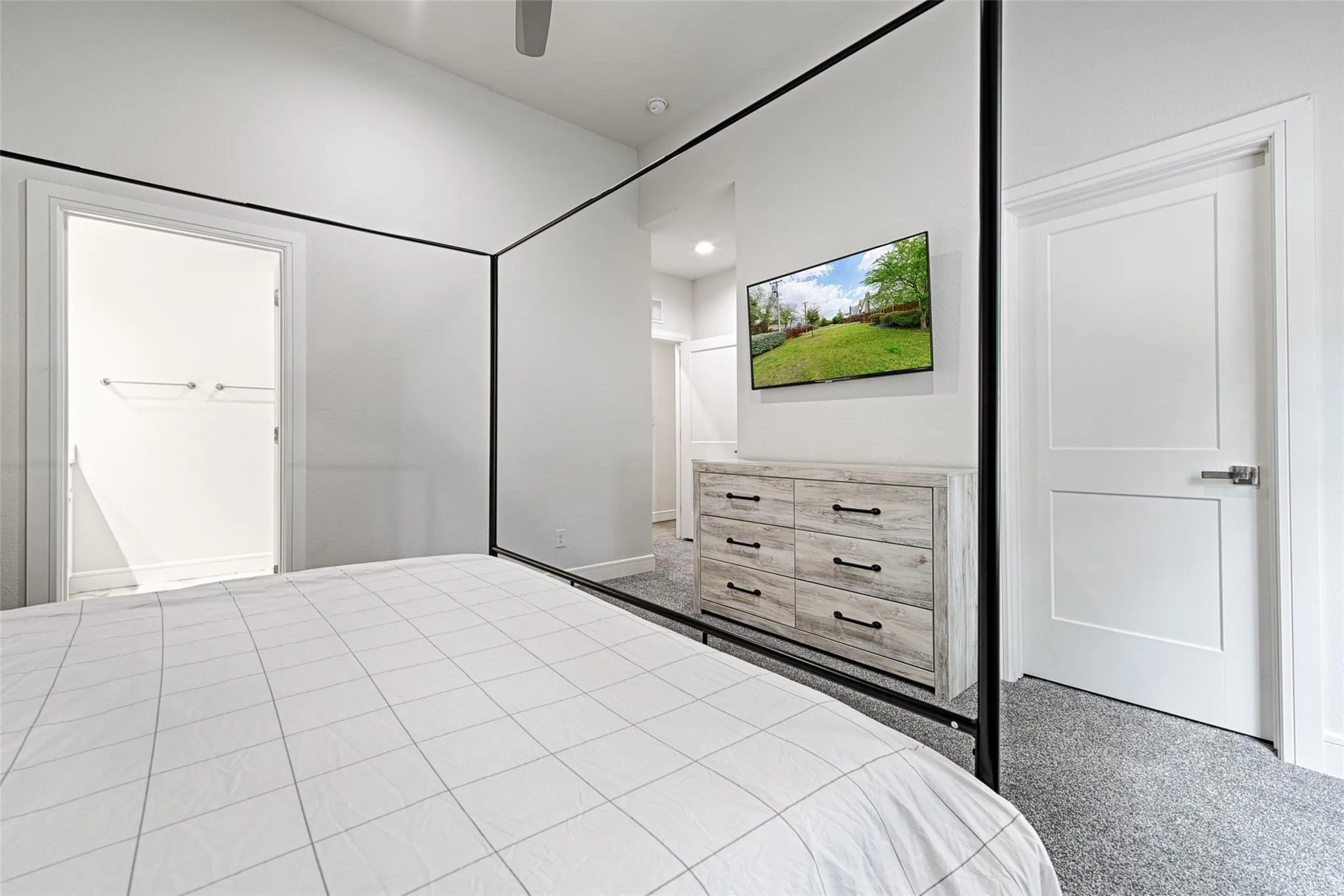 Recessed lighting, a ceiling fan, plush gray carpeting, and paneled interior doors