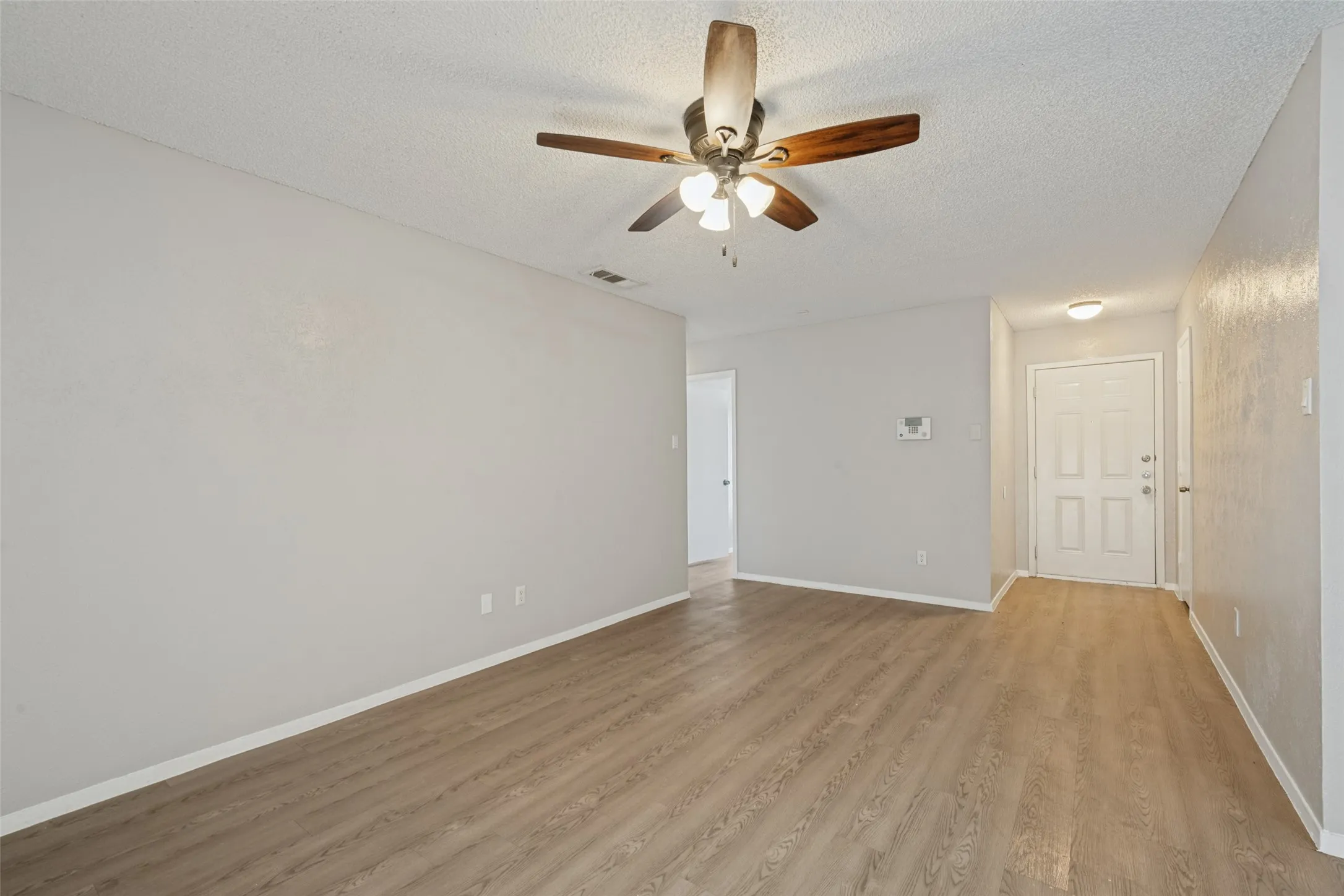 Wood-finish flooring throughout, complemented by light gray walls