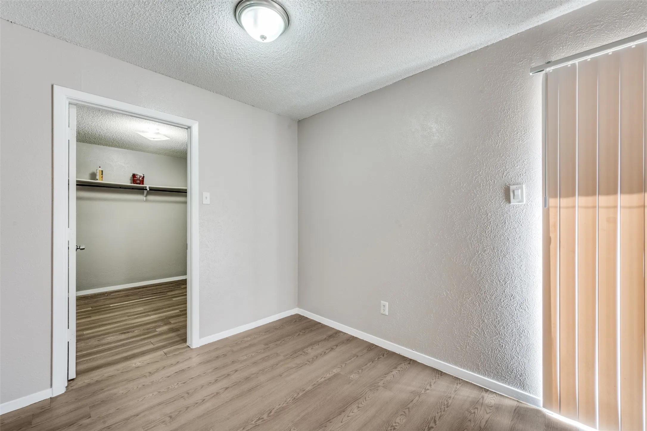Neutral-toned walls complement wood-finish flooring