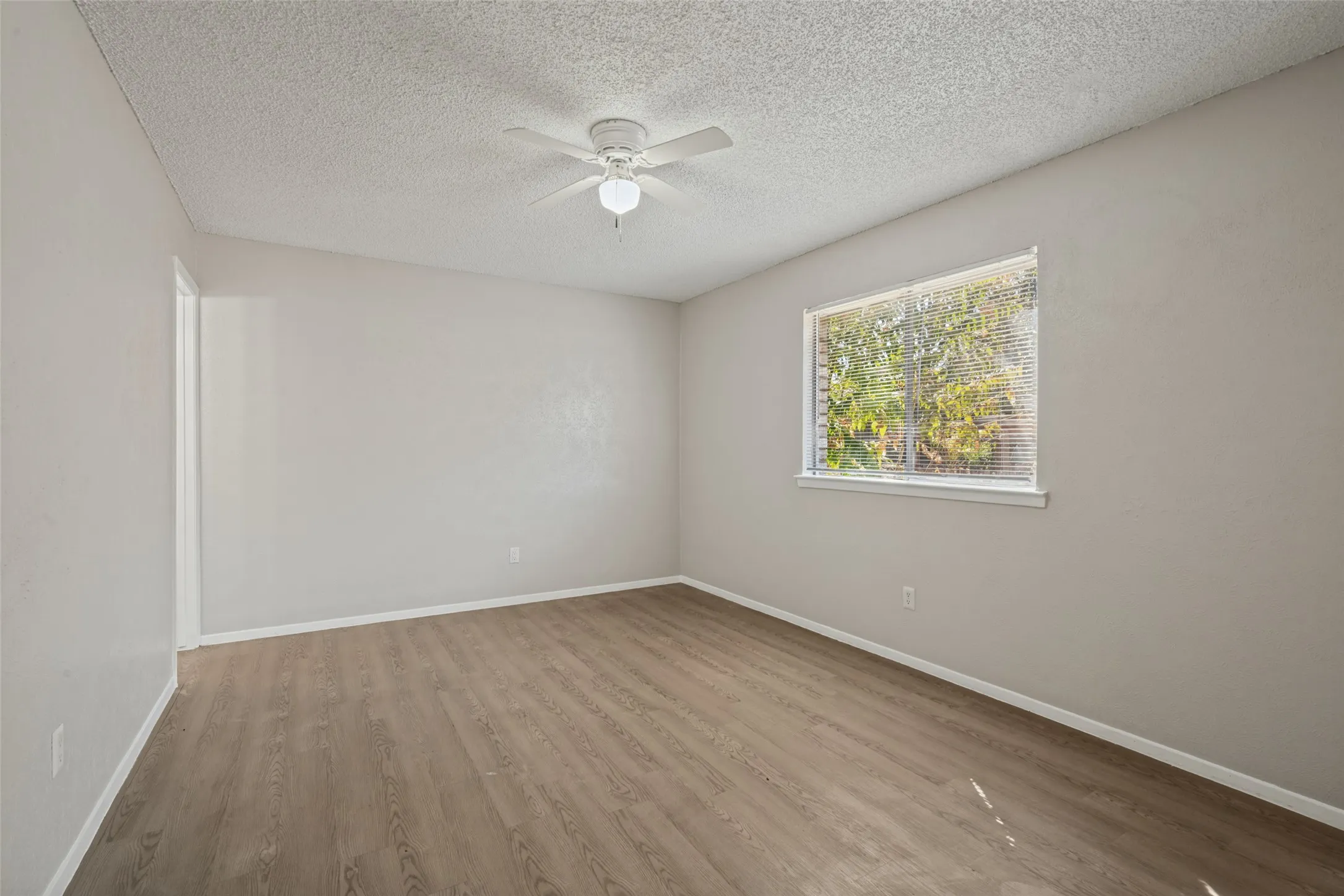 Neutral wall color with wood-finish flooring