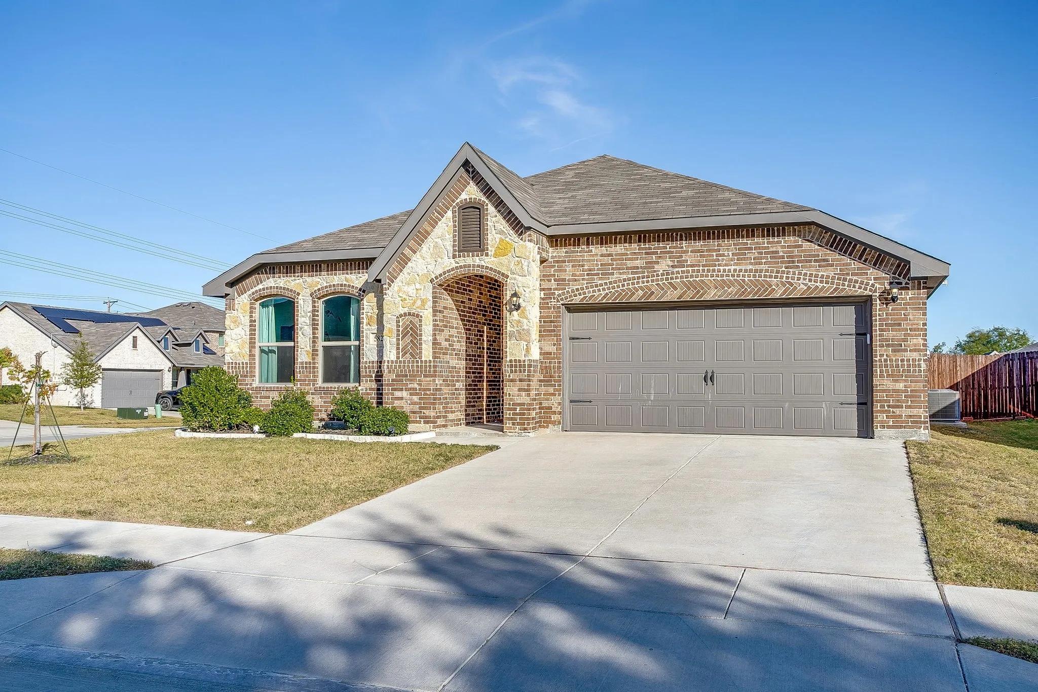 Brick and stone exterior with an arched entry