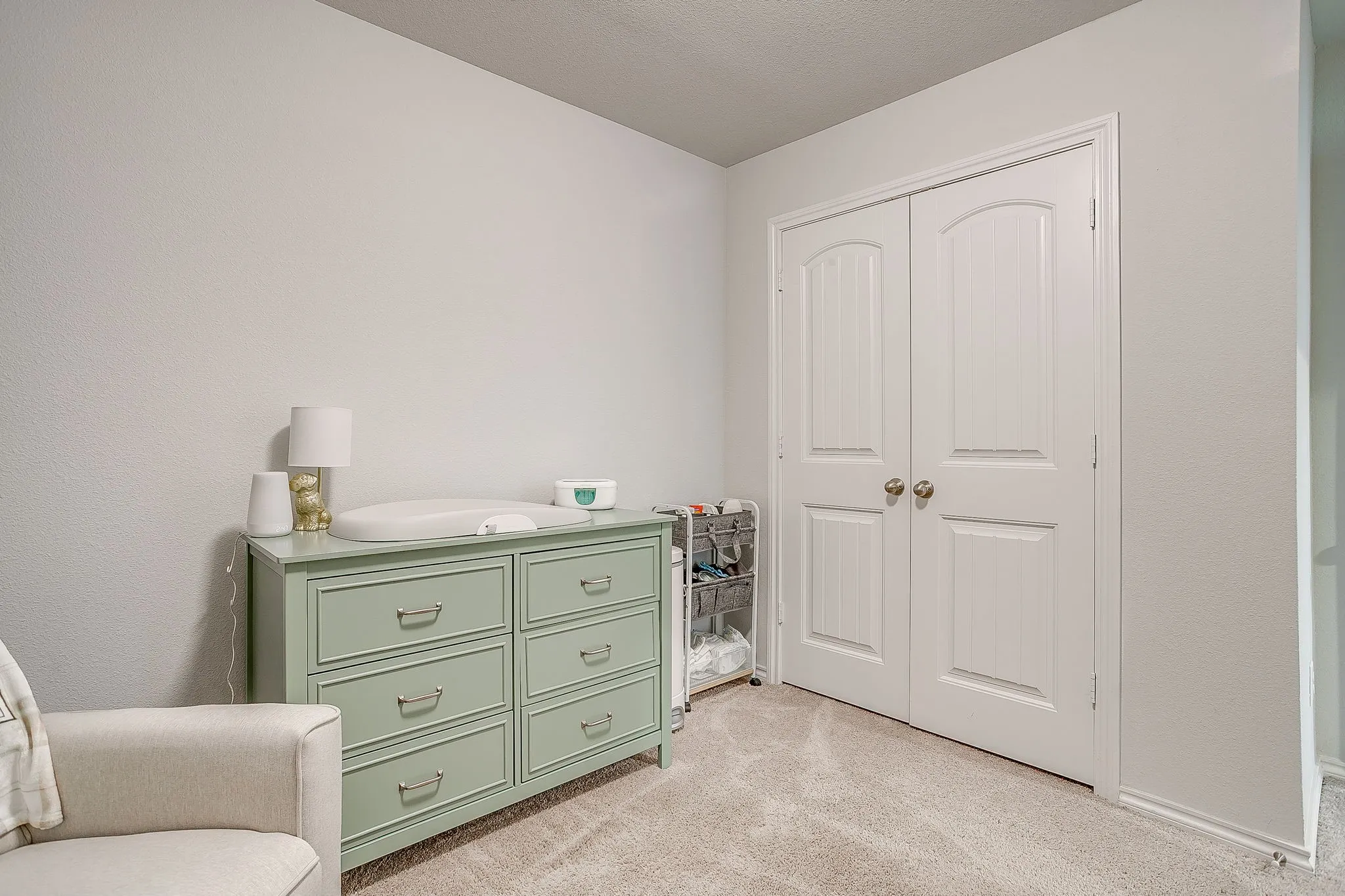 Soft neutral wall color, plush carpeting, and double bi-fold doors