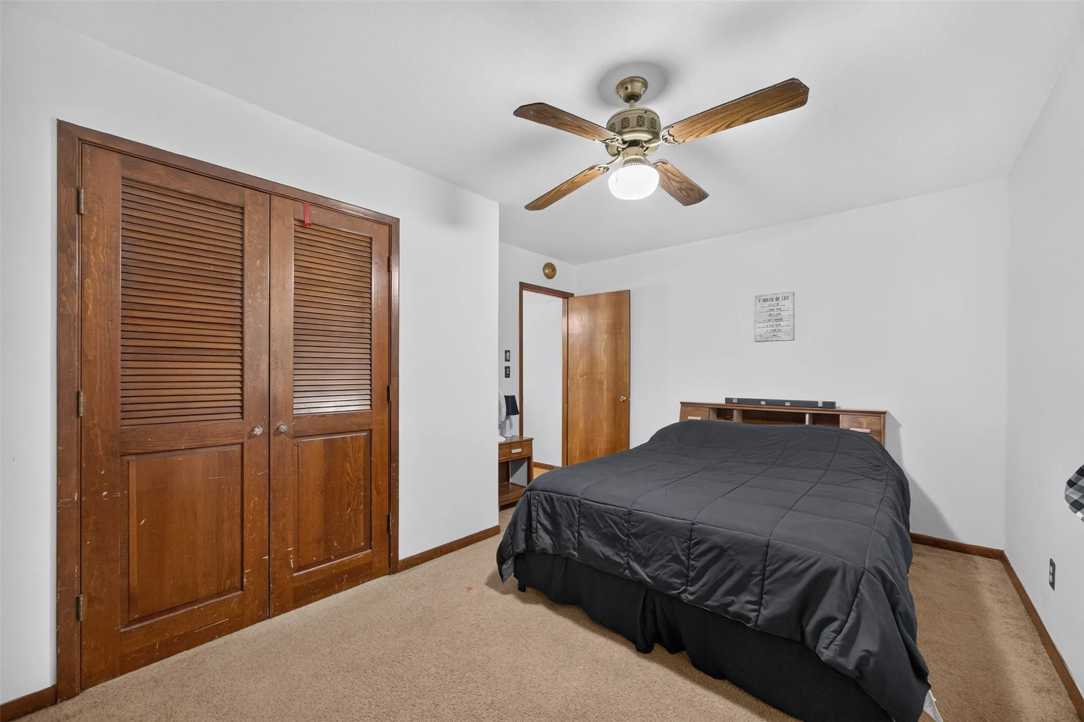 Recessed lighting, ceiling fan, carpeting, wood-finish bi-fold closet doors, and wood-finish interior door